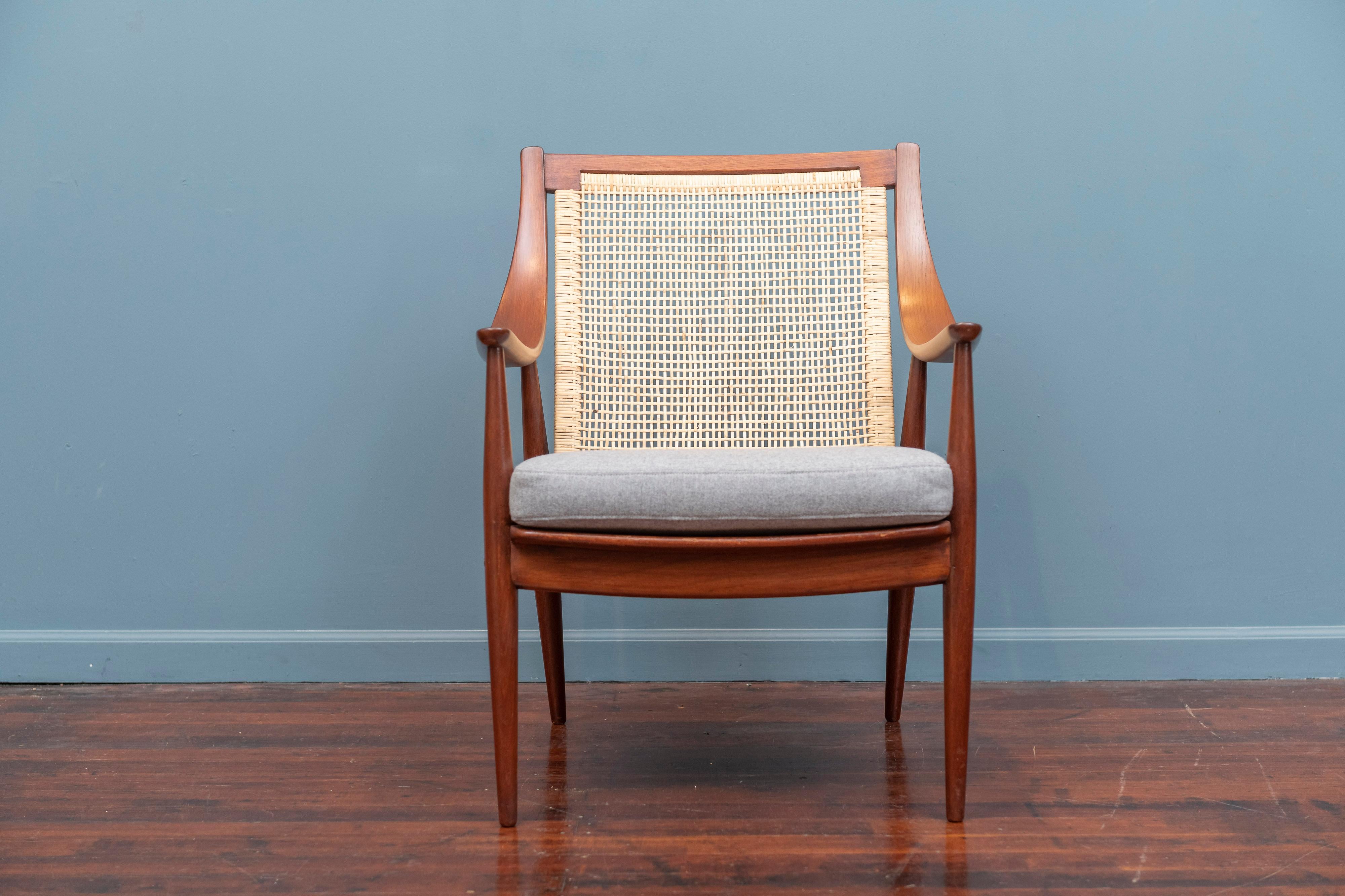 Peter Hvidt & Orla Morgaard Nielsen design armchair, Denmark. Refinished teak wood frame with a newly caned backrest, upholstered cushion and new seat straps. Extremely comfortable and ready to install.