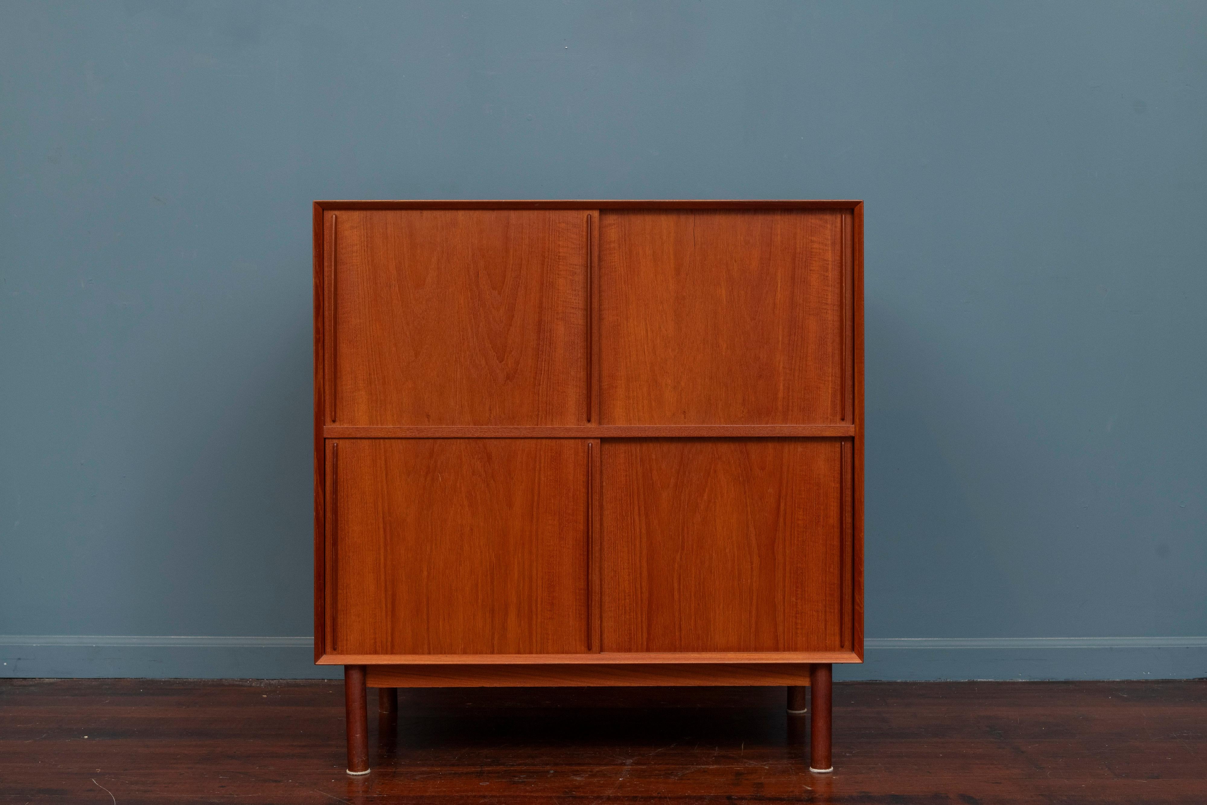Peter Hvidt & Orla Morgaard-Nielsen cabinet for Soborg Mobler, Denmark. High quality solid teak construction case with bentwood sliding doors and two adjustable shelves. Simple elegance is achieved in this very practical and functional cabinet on