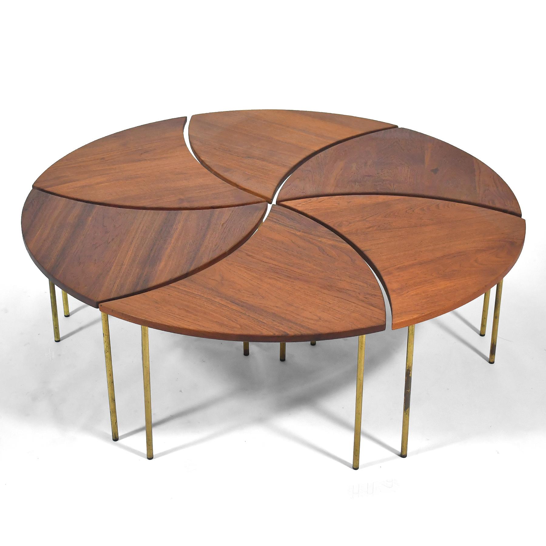 La table basse modèle #523 de France & Son est une création brillamment inventive de Peter Hvidt. Elle se compose de 6 tables individuelles en teck massif avec des pieds en laiton.  Lorsqu'elles sont disposées comme indiqué, elles forment un cercle