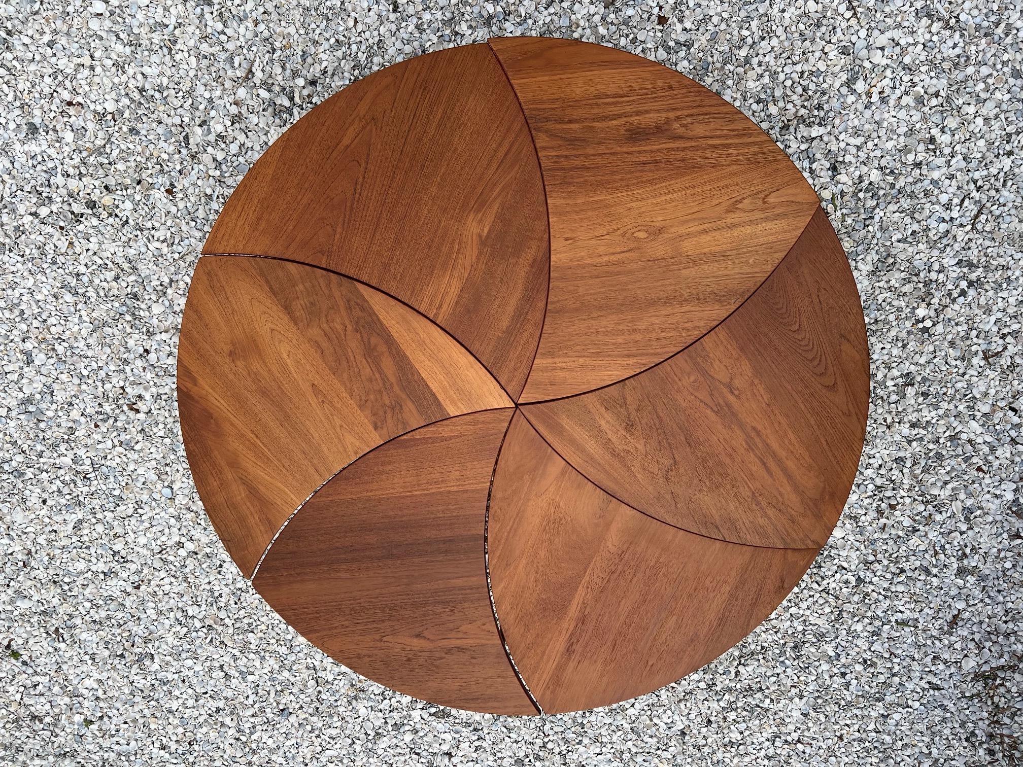 A fun pinwheel coffee table by Peter Hvidt. Composed of six (6) separate tables and limitless possibilities for arrangement. Made of teak and brass.