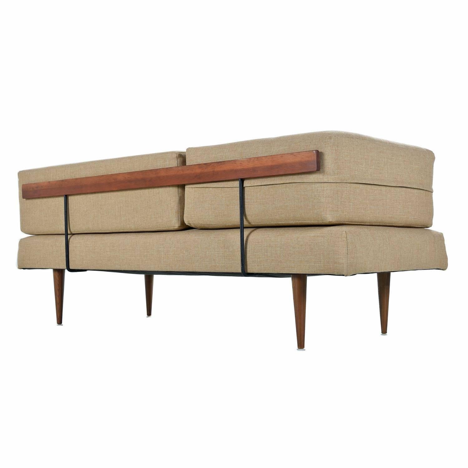 Restored Mid-Century Modern daybed sofa in the style of Peter Hvidt. Unique elbow shaped bolster cushion allows this sofa the fit neatly into a standard 90 degree corner. The sofa does not have to be relegated to the corner. This stylish daybed is