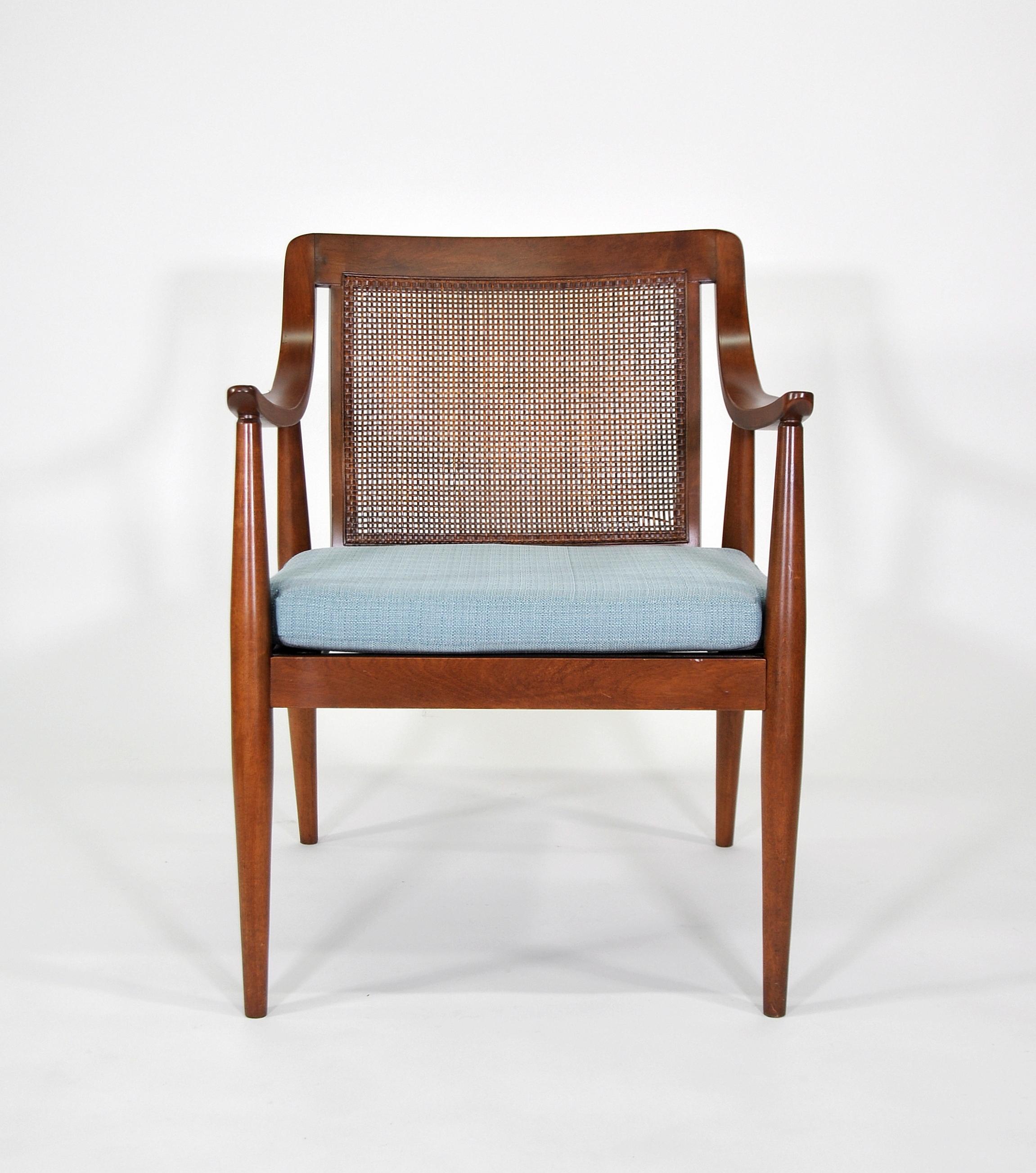 A lovely vintage Mid-Century Modern armchair with caned back in the manner of Peter Hvidt and Olga Molgaard-Nielsen, dating from the 1960s. The loose cushion is brand new and has a light azure sky blue or turquoise linen blend fabric. A great accent