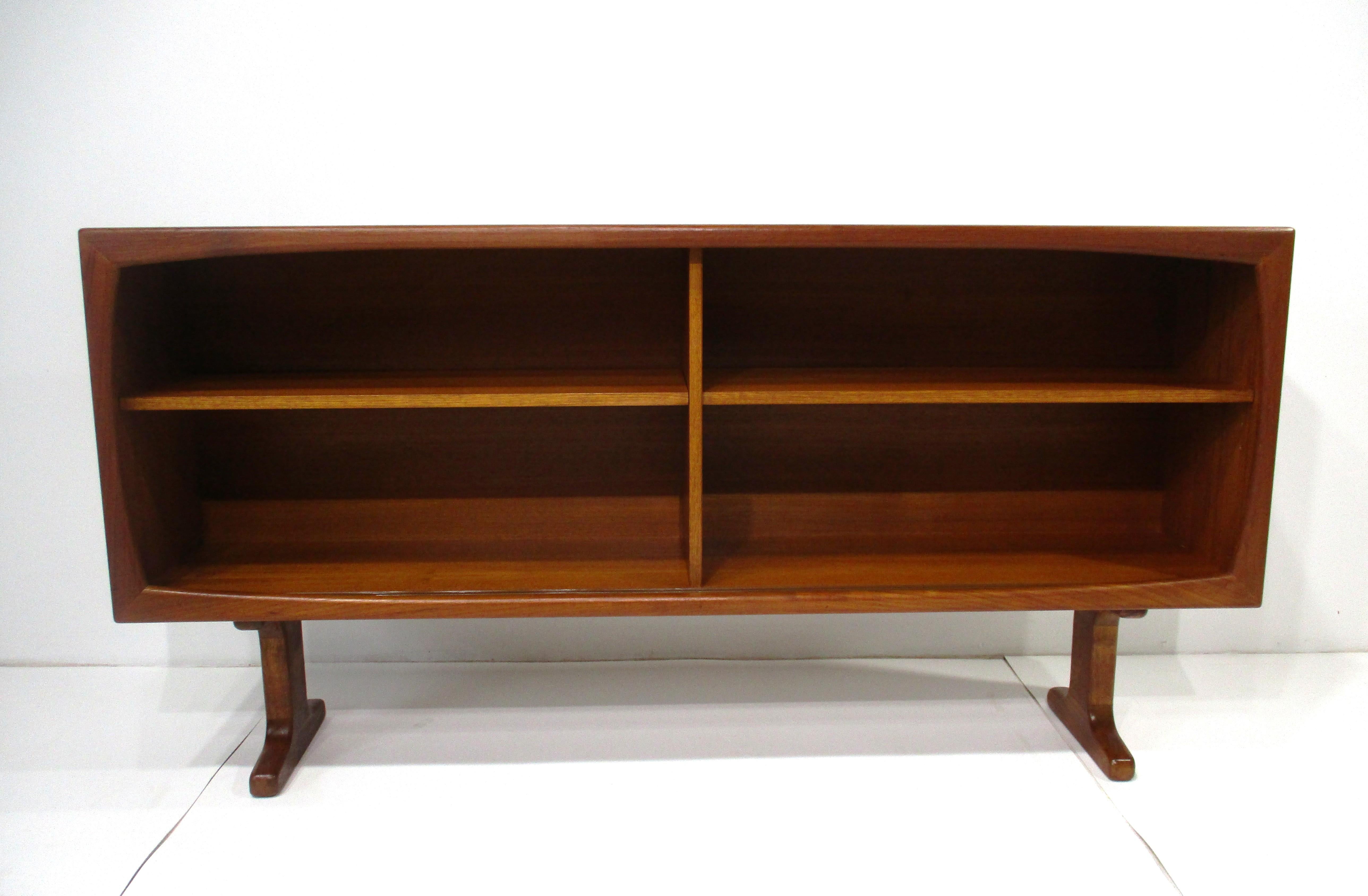 A very well crafted teak wood bookcase with two smoked glass sliding doors and two adjustable shelves and having a fully finished back could be used as a room divider in a loft or large open area . The size and proportions of this functional case