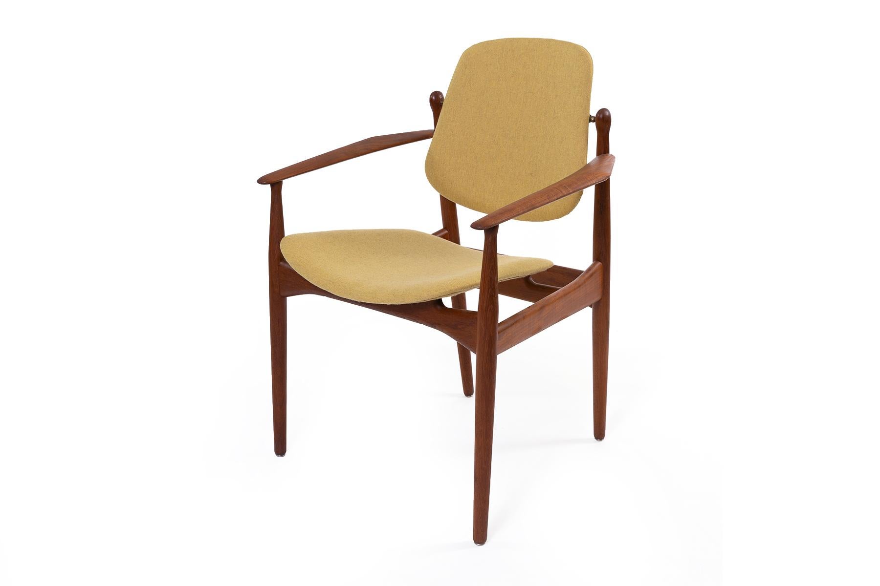 8 solid teak and brass Danish dining chairs by Peter Hvidt. Newly upholstered in mustard Perry wool. Collection includes two armchairs measuring 25