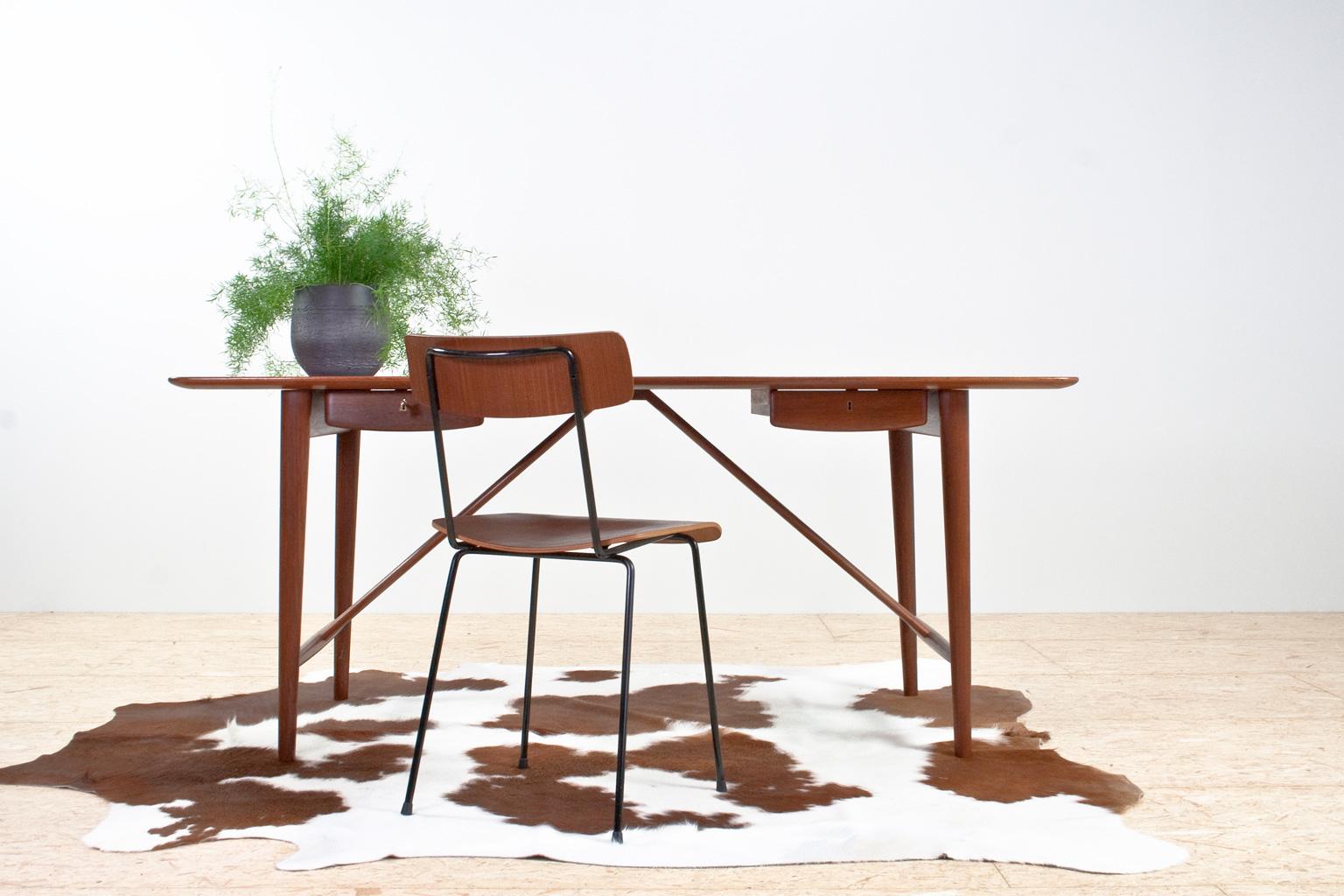 Scandinavian Modern elegant Peter Hvidt (1916-1986) and Orla Mølgaard-Nielsen (1907-1993) desk, designed in 1955 (model 301) for Søborg Møbler. The item features a solid wooden teak tabletop and elegant tapered legs. The desk has two deep drawers