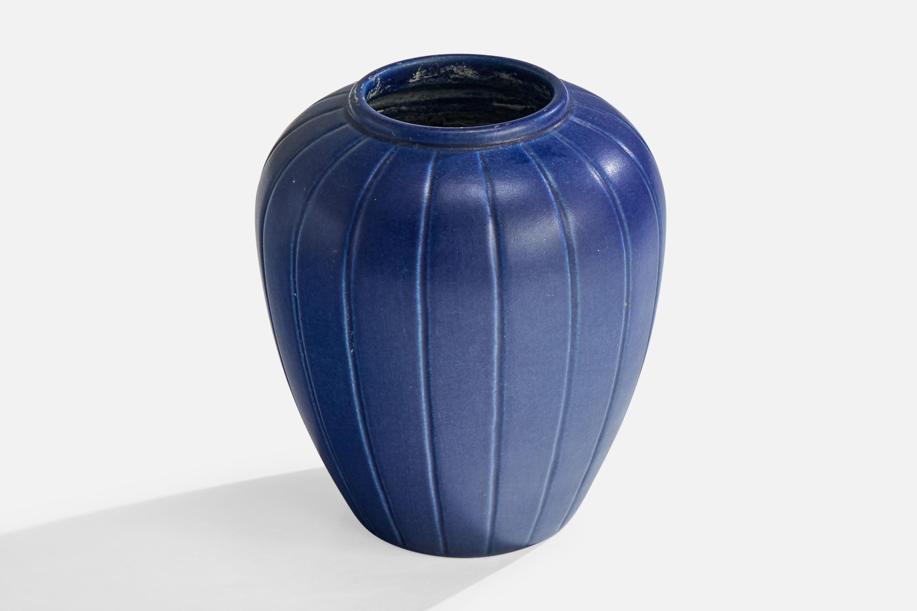 A blue-glazed fluted stoneware vase produced by Peter Ipsen Enke, Denmark, c. 1940s.

Overall Dimensions (inches): 5.0