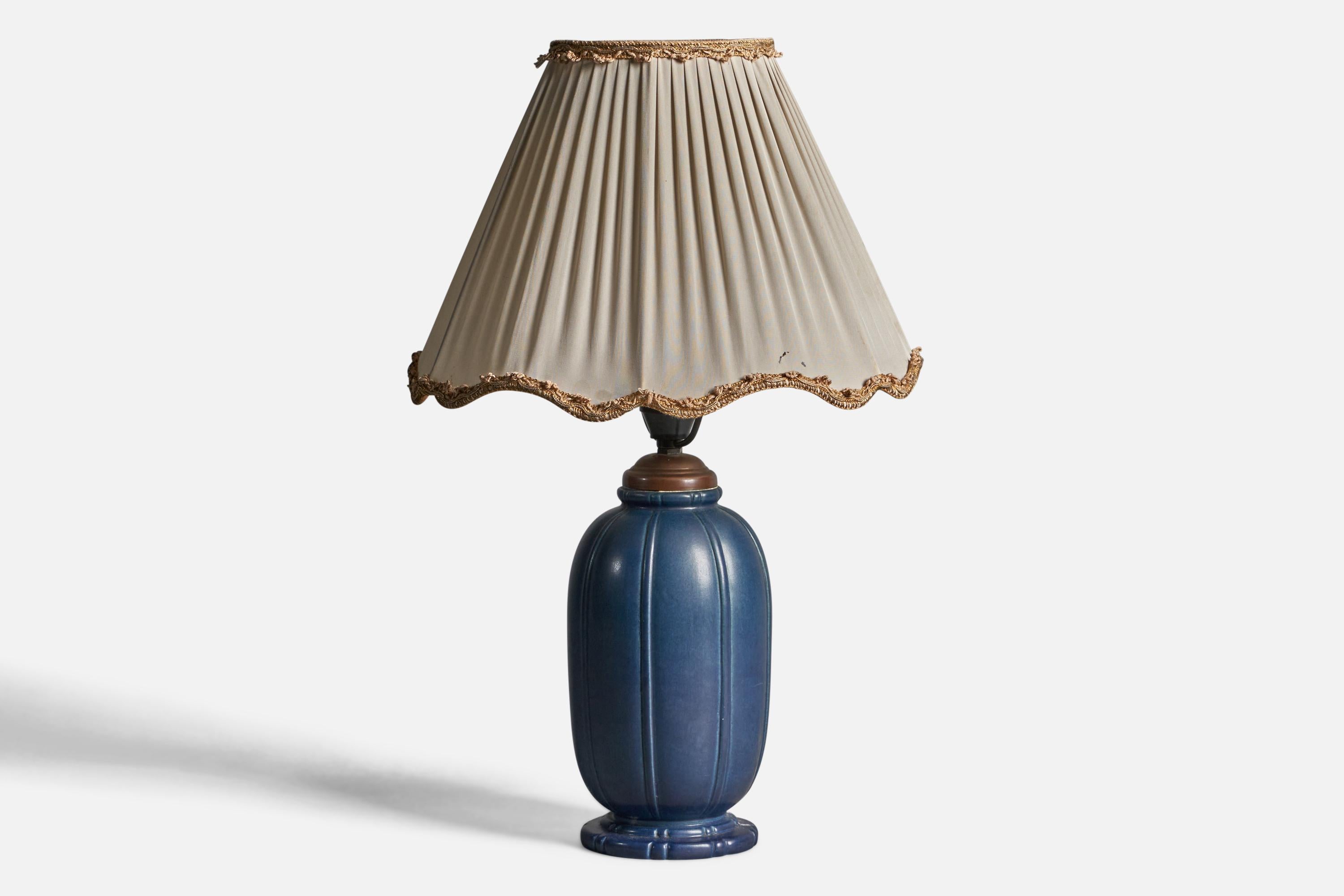 A blue-glazed stoneware, brass and beige fabric table lamp, designed and produced by Peter Ipsens Enke, Denmark, 1940s.

Overall Dimensions (inches): 19