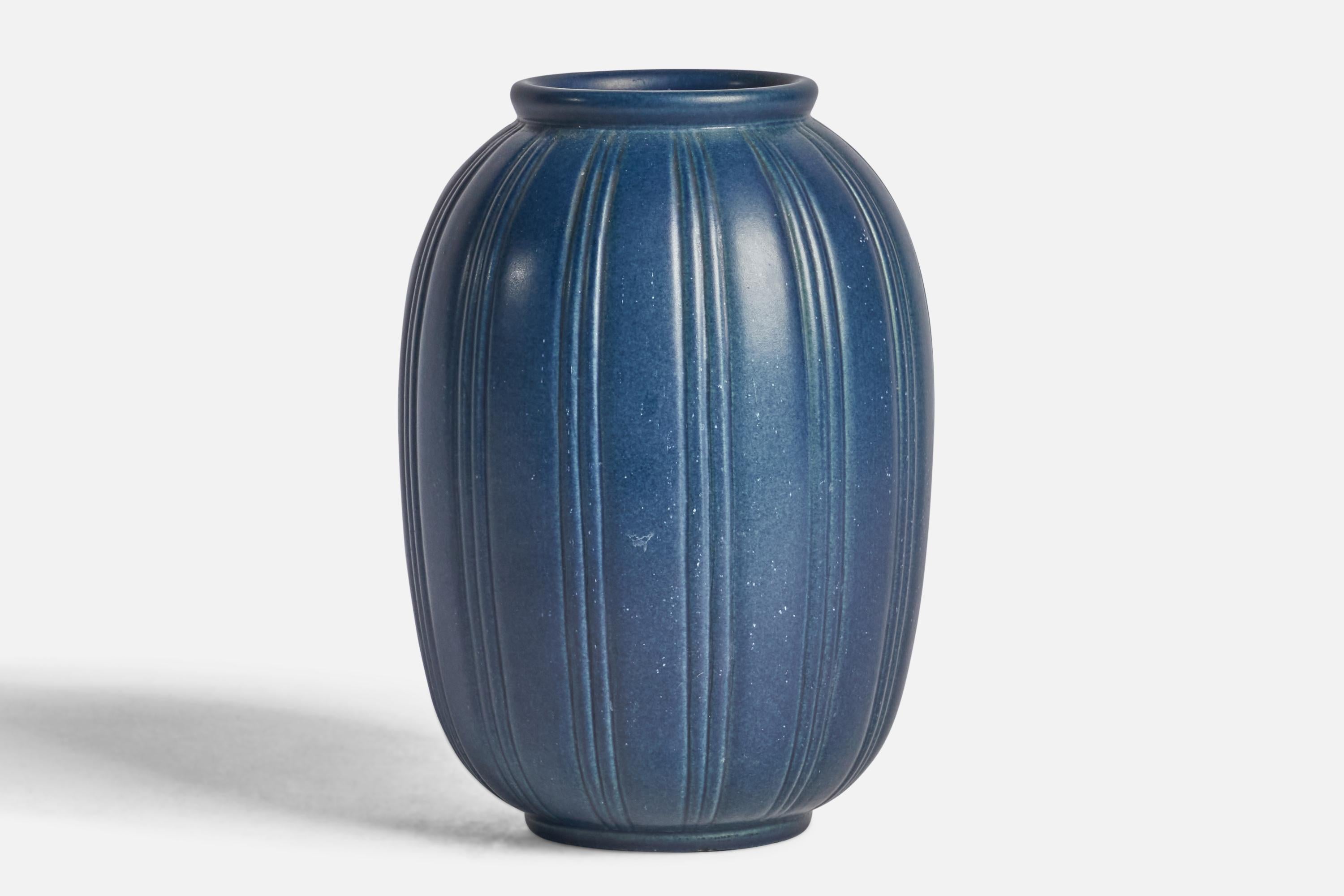 A blue-glazed fluted stoneware vase designed and produced by Peter Ipsens Enke, Denmark, 1940s.
