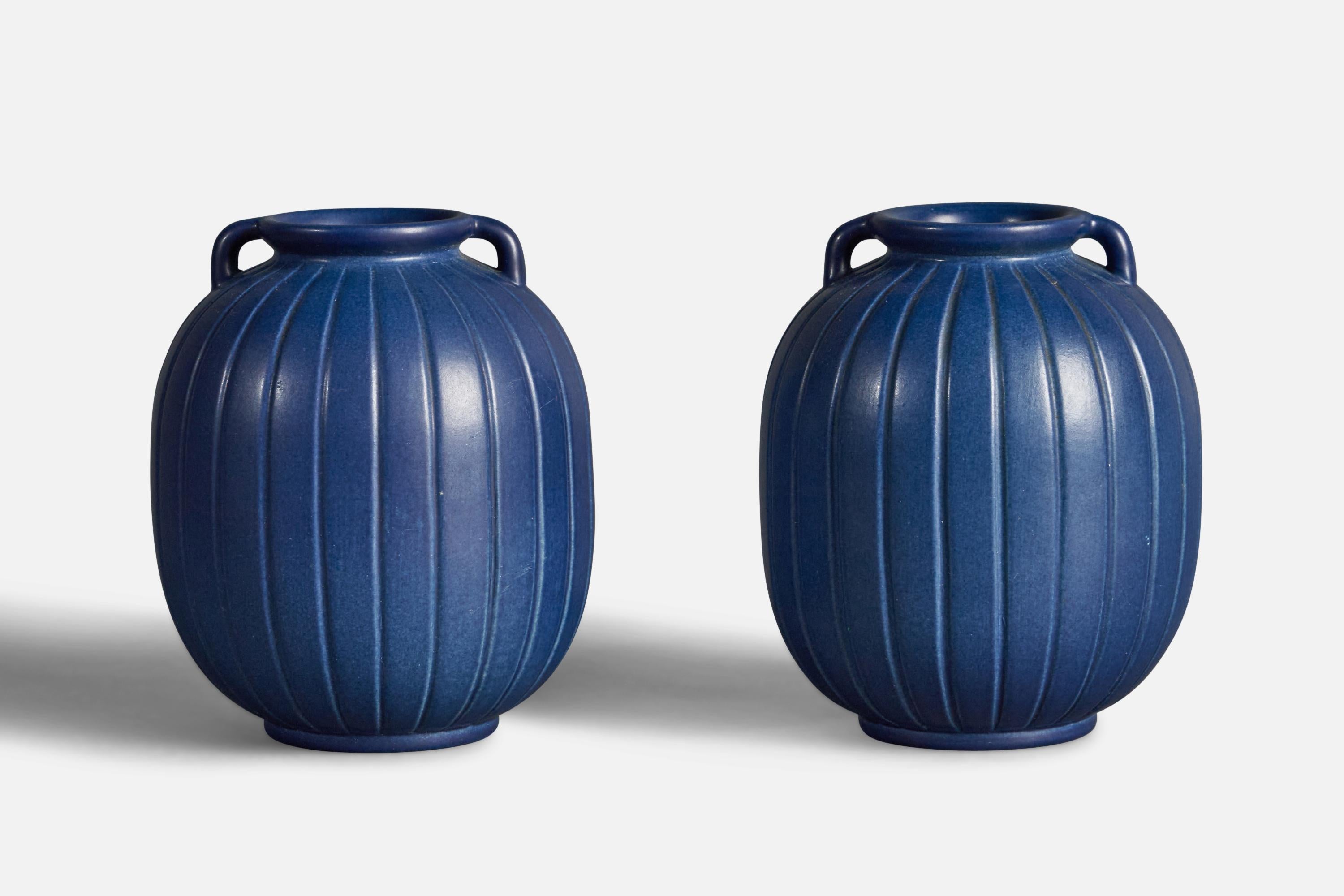 A pair of blue-glazed and fluted stoneware vases designed and produced by Peter Ipsens Enke, Denmark, 1940s.