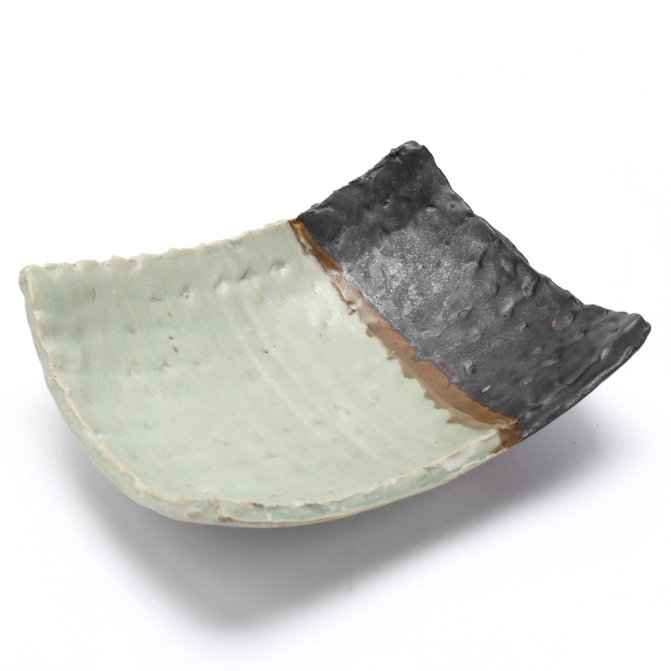 One-of-a-kind, early hand-built rectangular dish with dimpled pattern in black and celadon glazes. Authenticity confirmed by artist. Lane's work is known around the world and is part of the permanent collection of the Museum of Decorative Arts,