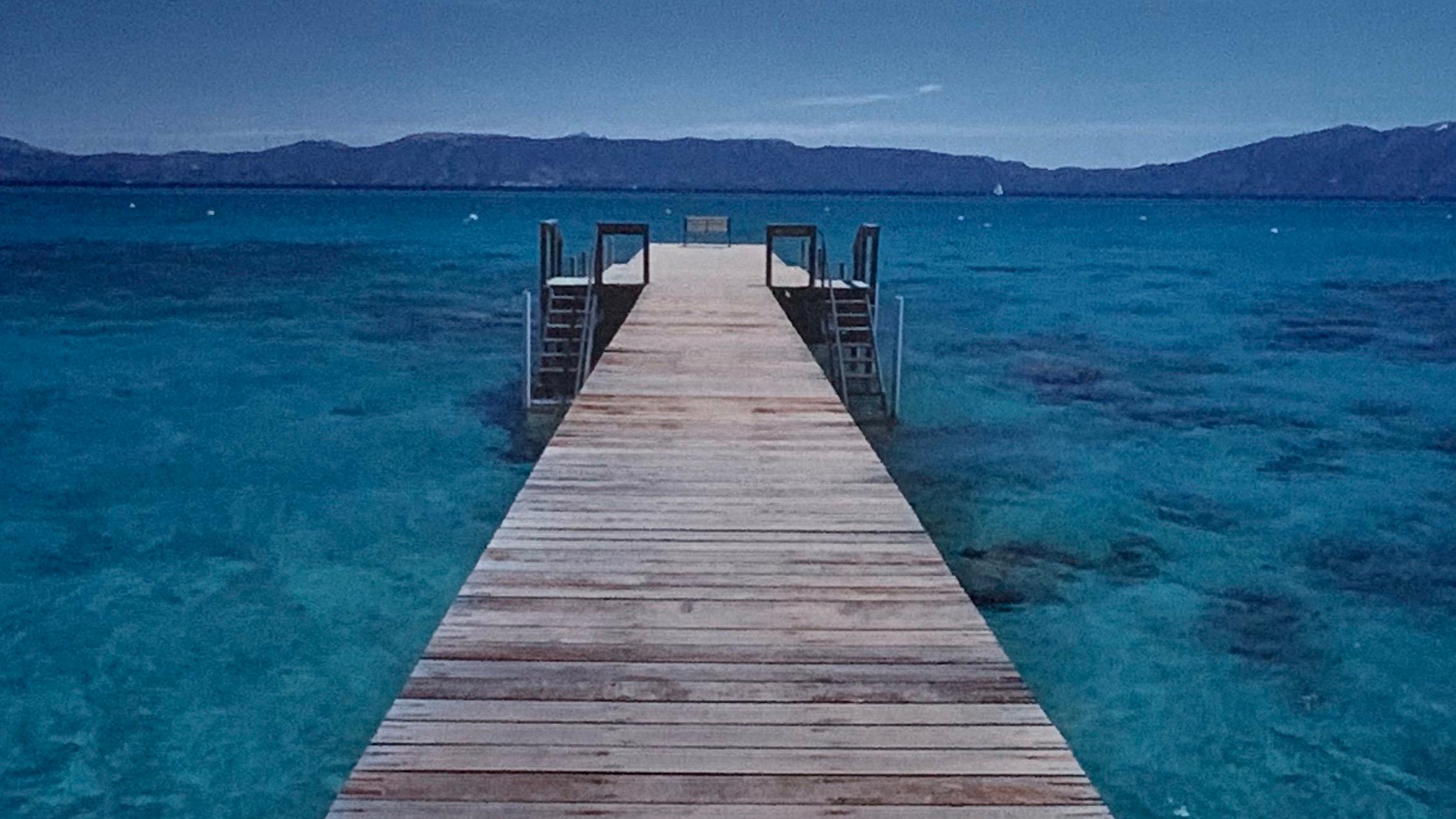 Peter lik Australian photographer, gallery framed and floating mounted. This print is of Lake Tahoe and features the jetty set against the snow capped mountains. Fully signed in gold pen with COA included.