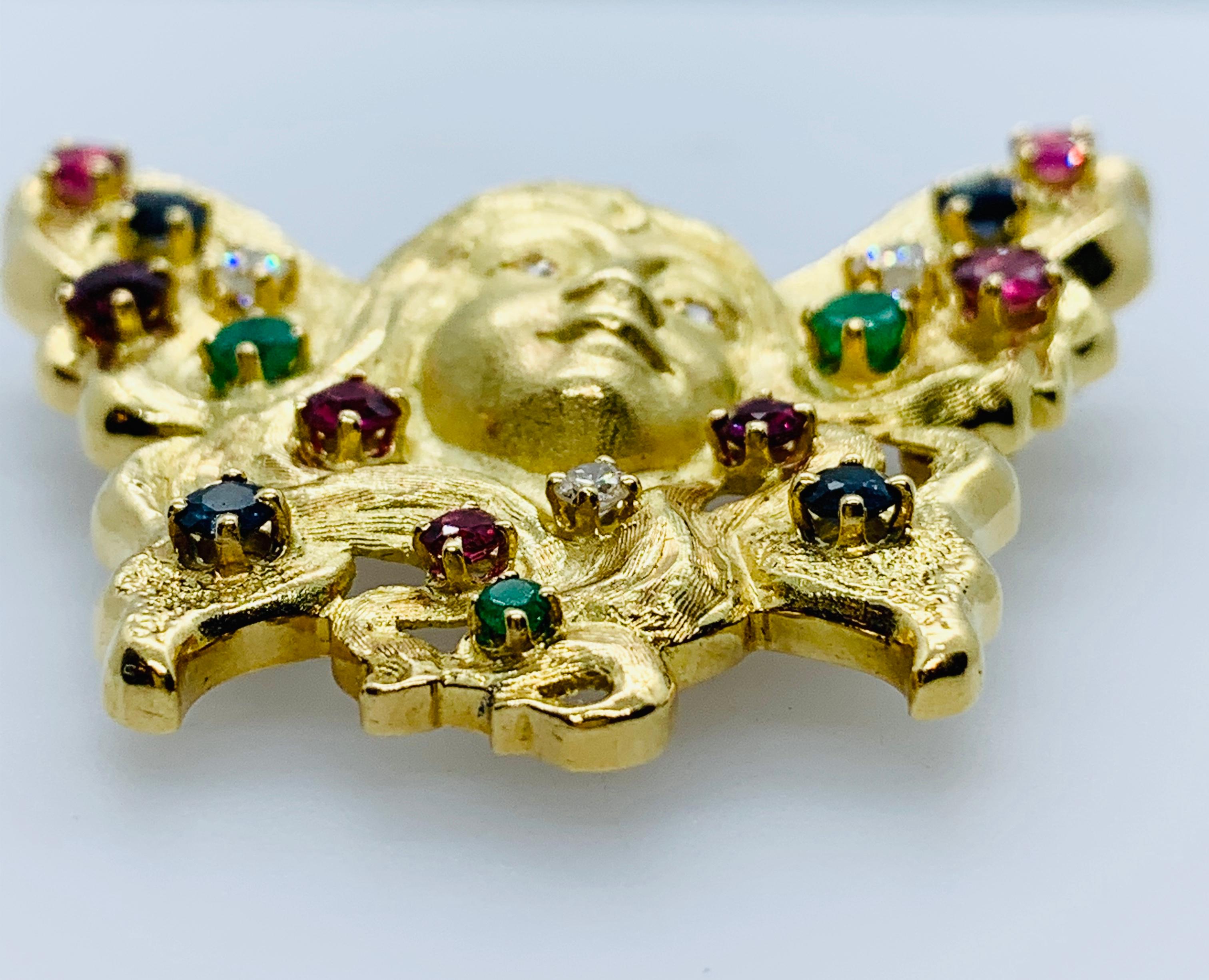 Absolutely Stunning Peter Lindeman 18K Yellow Gold Art Nouveau Style Brooch & Enhancer! The piece features an angelic female face surrounded by butterfly wings...The piece is adorned with seven round rubies, four roundSapphires, three round Emeralds