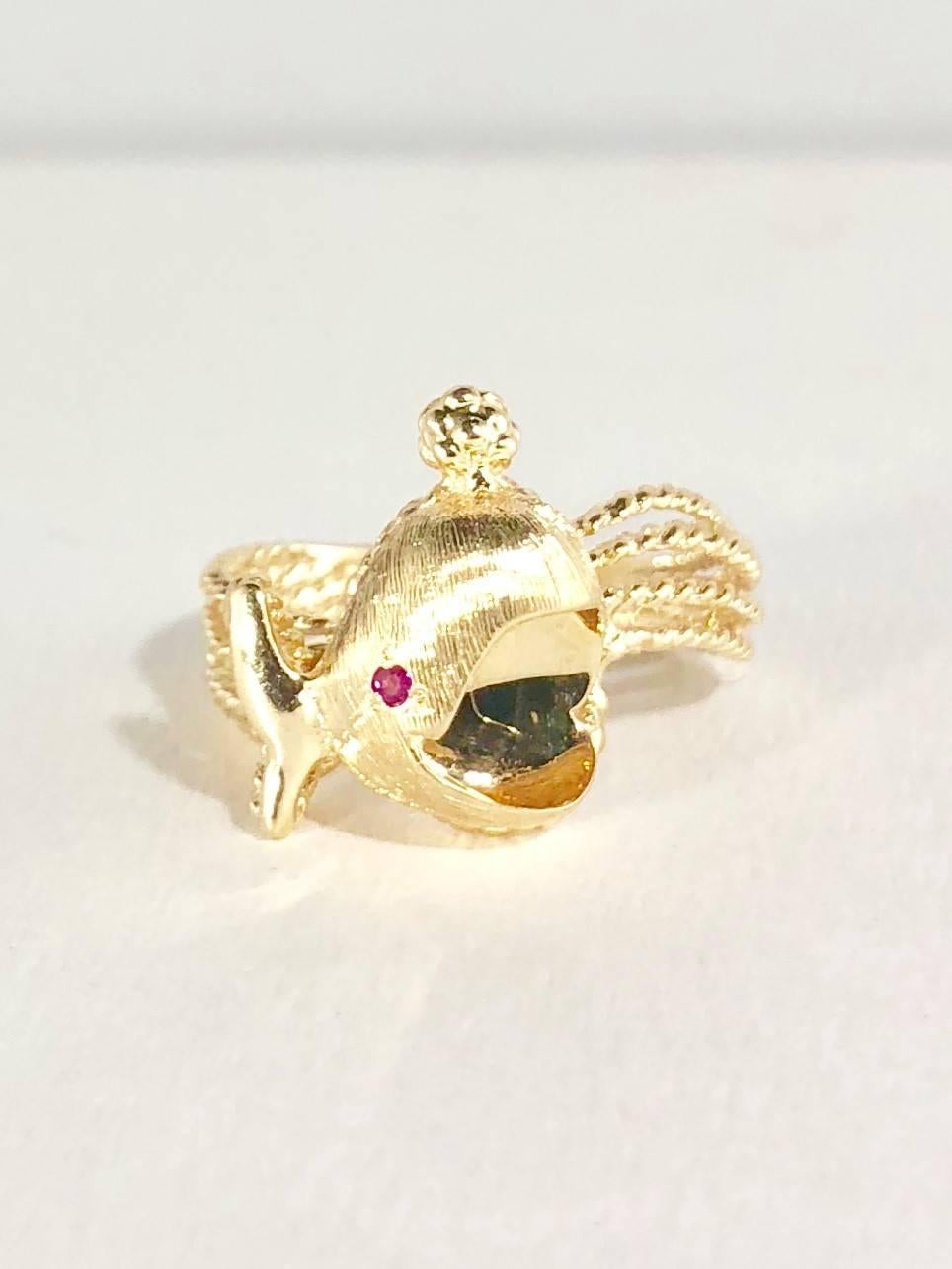 Peter Lindeman original 14 karat and Ruby Whale motif fashion ring. This ring is created in 14 karat yellow gold weighing 4.8 grams/3.1 dwt. The design includes a .02 carat total weight Ruby. This is a pre-owned modern/vintage piece. Circa 1970.