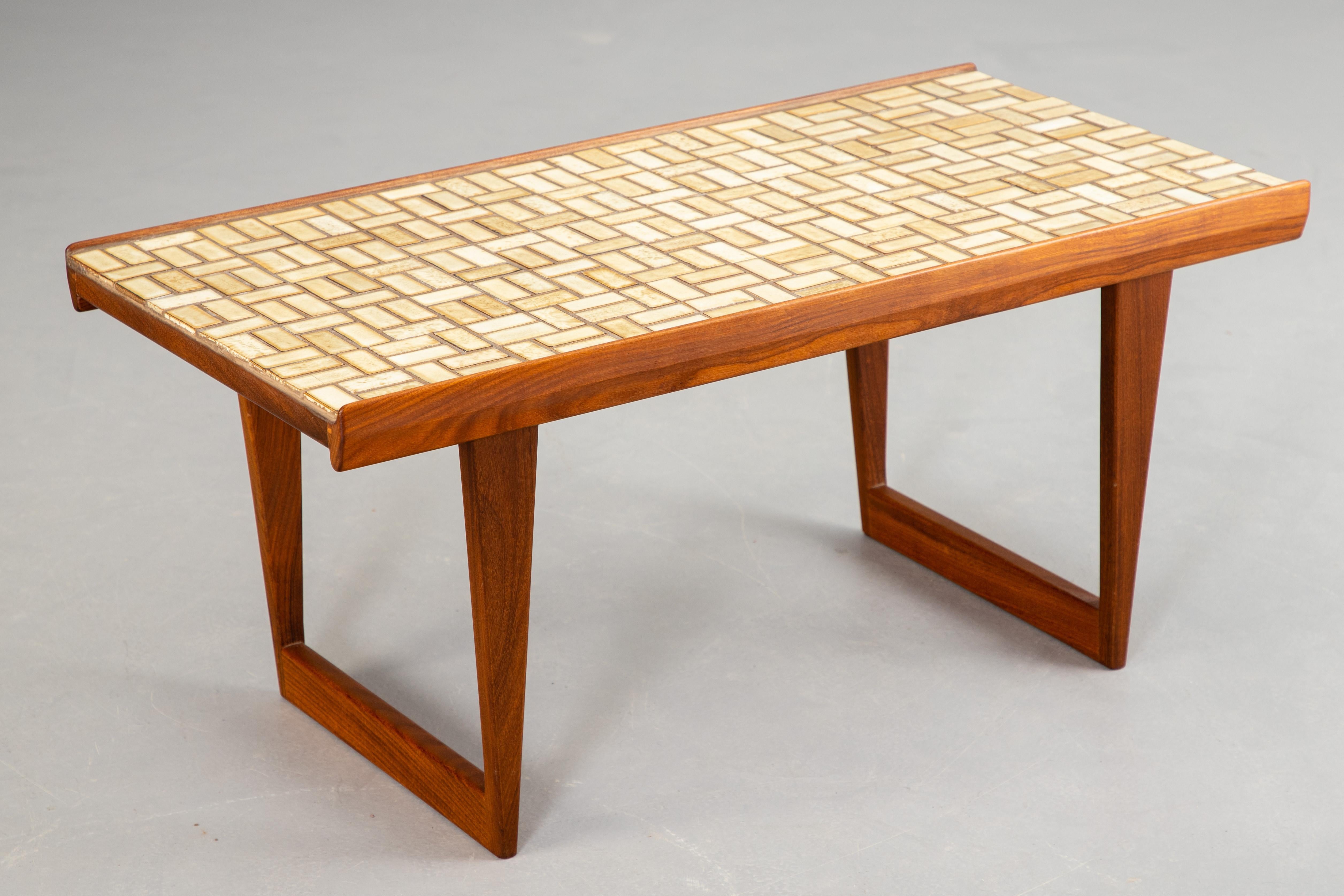 Teak side table rare model by Peter Lovig. made in Denmark, 1950s/60s. Teak construction, with tiled ceramic surface and grooved longitudinal edges made of solid teak wood. Marked on the underside.
Good condition 