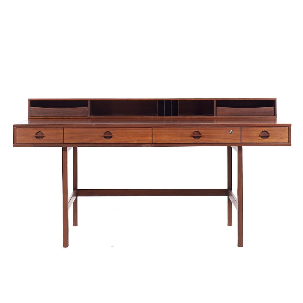 Peter Lovig Mid Century Danish Teak Flip Top Desk

This desk measures: 63.75 wide x 28.75 deep x 28.75 high, with a chair clearance of 23.5 inches
When the flip shelf is down the depth is 38 inches
When the flip shelf is engaged the height is 34