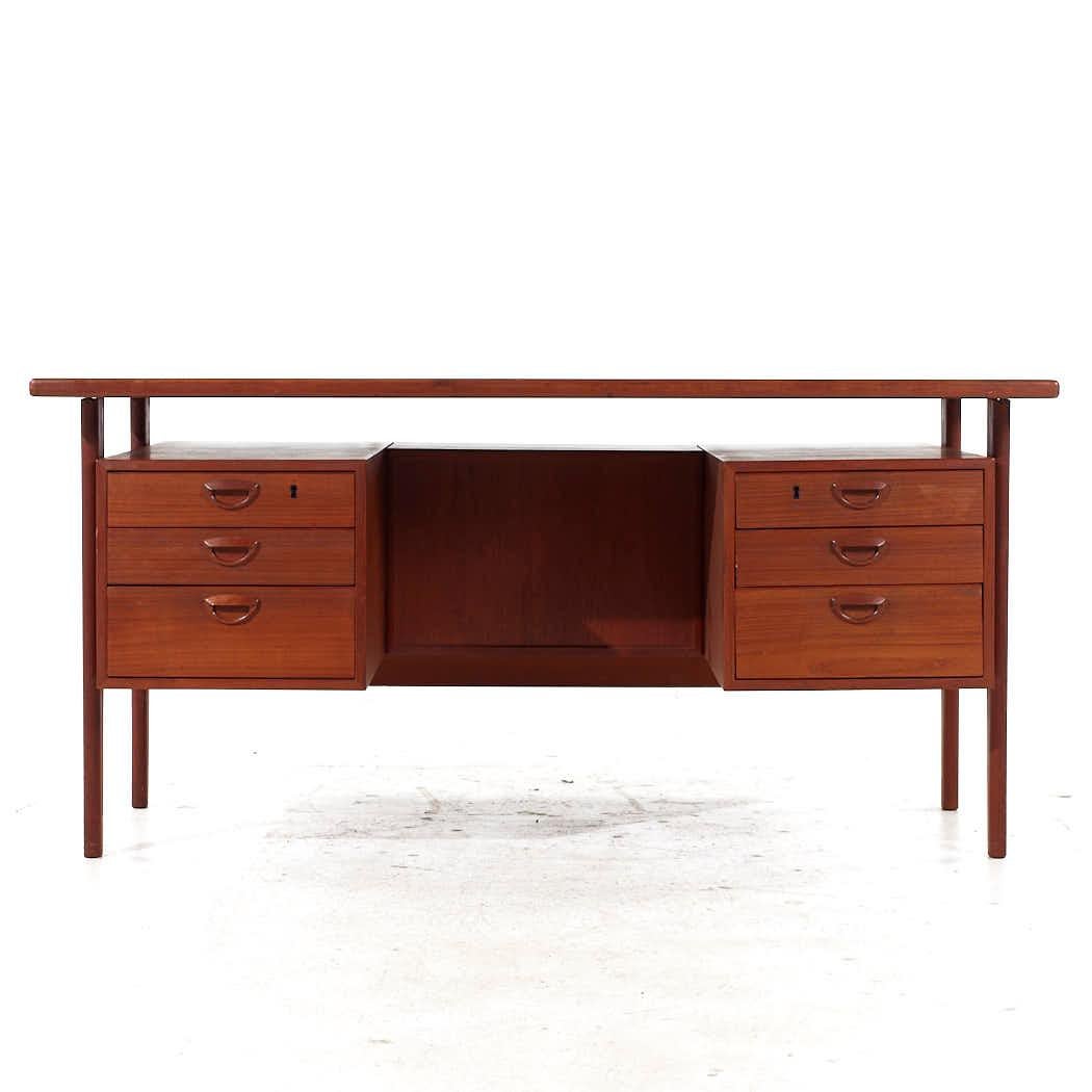 Peter Lovig Mid Century Teak Executive Desk

This desk measures: 59.75 wide x 30.5 deep x 28.75 high, with a chair clearance of 27.5 inches

All pieces of furniture can be had in what we call restored vintage condition. That means the piece is