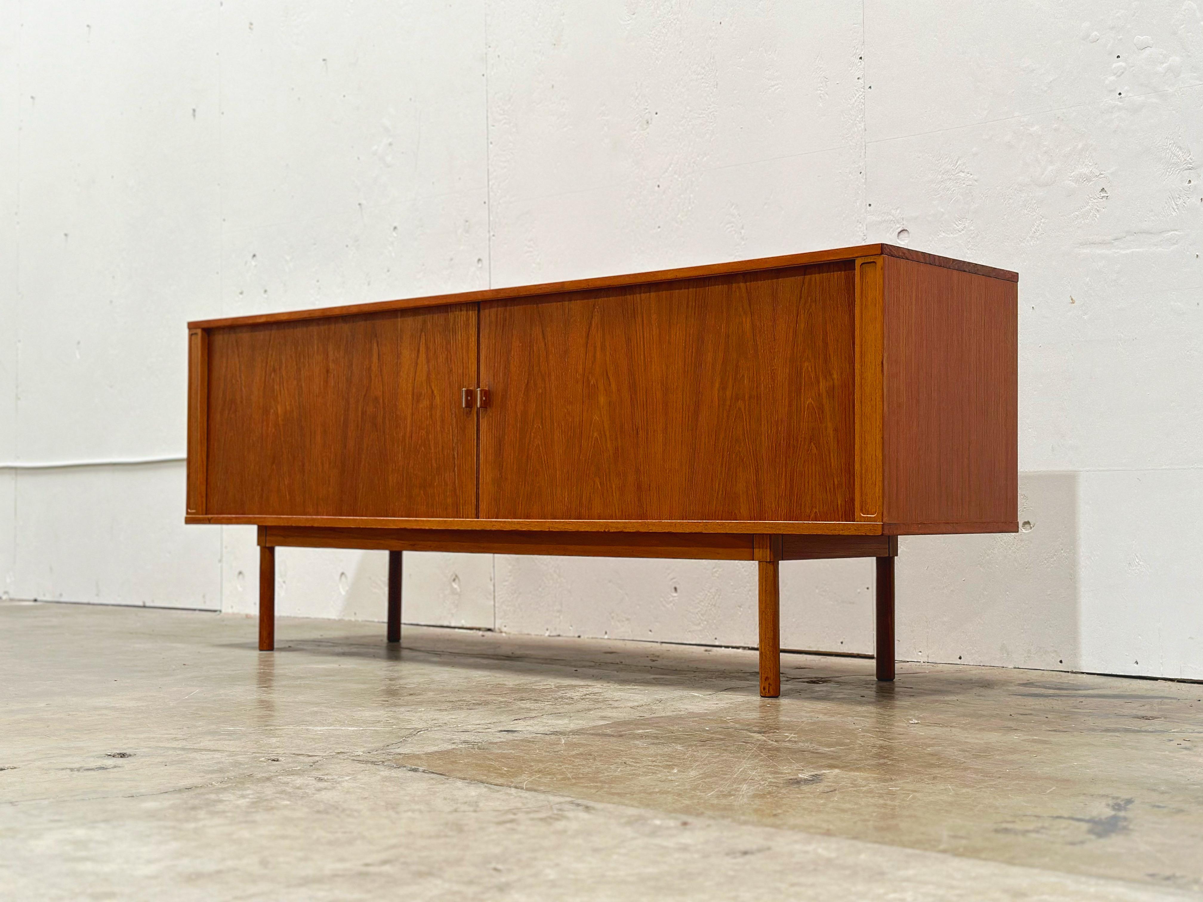 Mid century Danish modern credenza by Peter Løvig Nielsen for Løvig Design - Denmark, circa 1974.
Gorgeous teak with tambour doors, adjustable shelves and four drawers.
Fully restored and in excellent condition. Clean and ready for