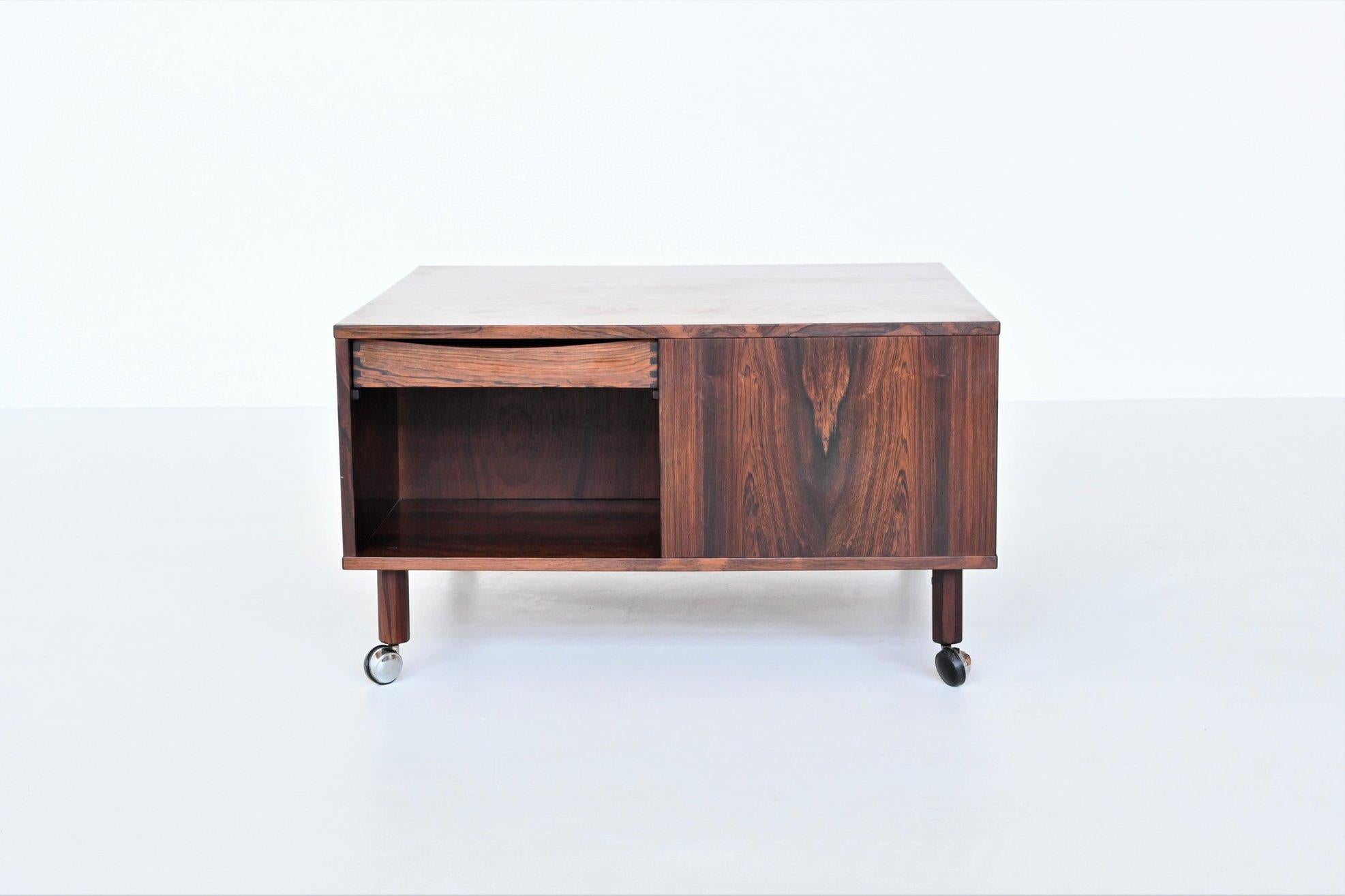 Beautiful and very unique “Cubus” coffee table designed by Peter Lovig Nielsen, Denmark 1960. This square shaped coffee table is executed in nicely grained rosewood that has rich fiery tones of black and red. It could easily be used as a media unit