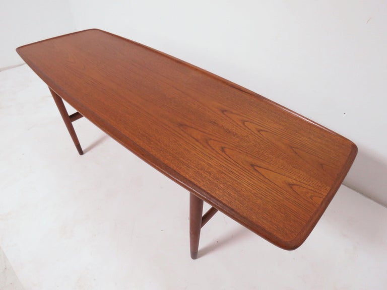 Teak coffee table with carved lip borders, designed by Peter Lovig Nielsen for Hedensted Mobelfabrik, Circa 1960s.