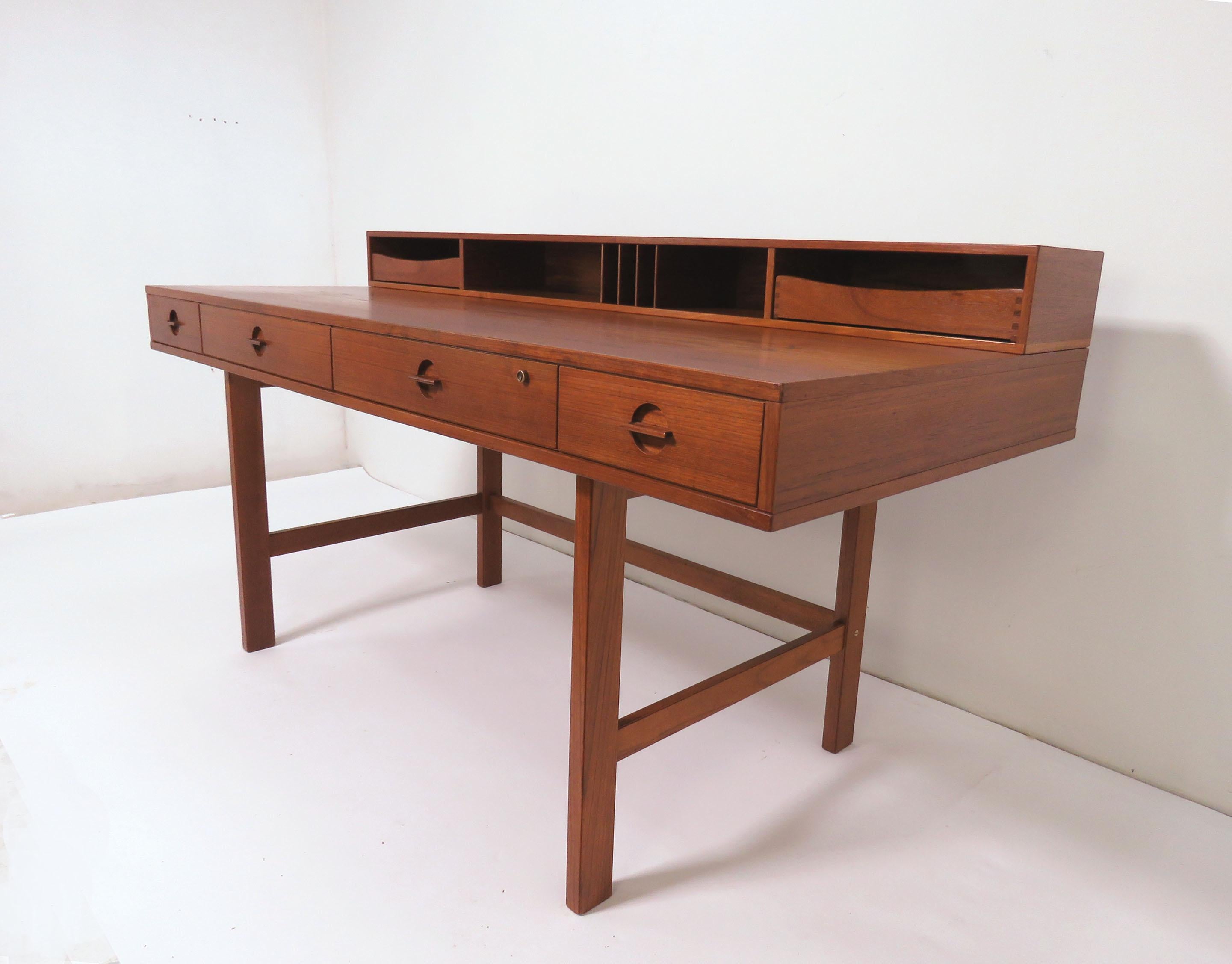 Teak desk by Peter Lovig Nielsen for Lovig, Denmark, circa 1972. Back hinged section can be used in upright position, includes slots for mail and organization drawers, or can be flipped down to create a larger worktop surface suitable as a