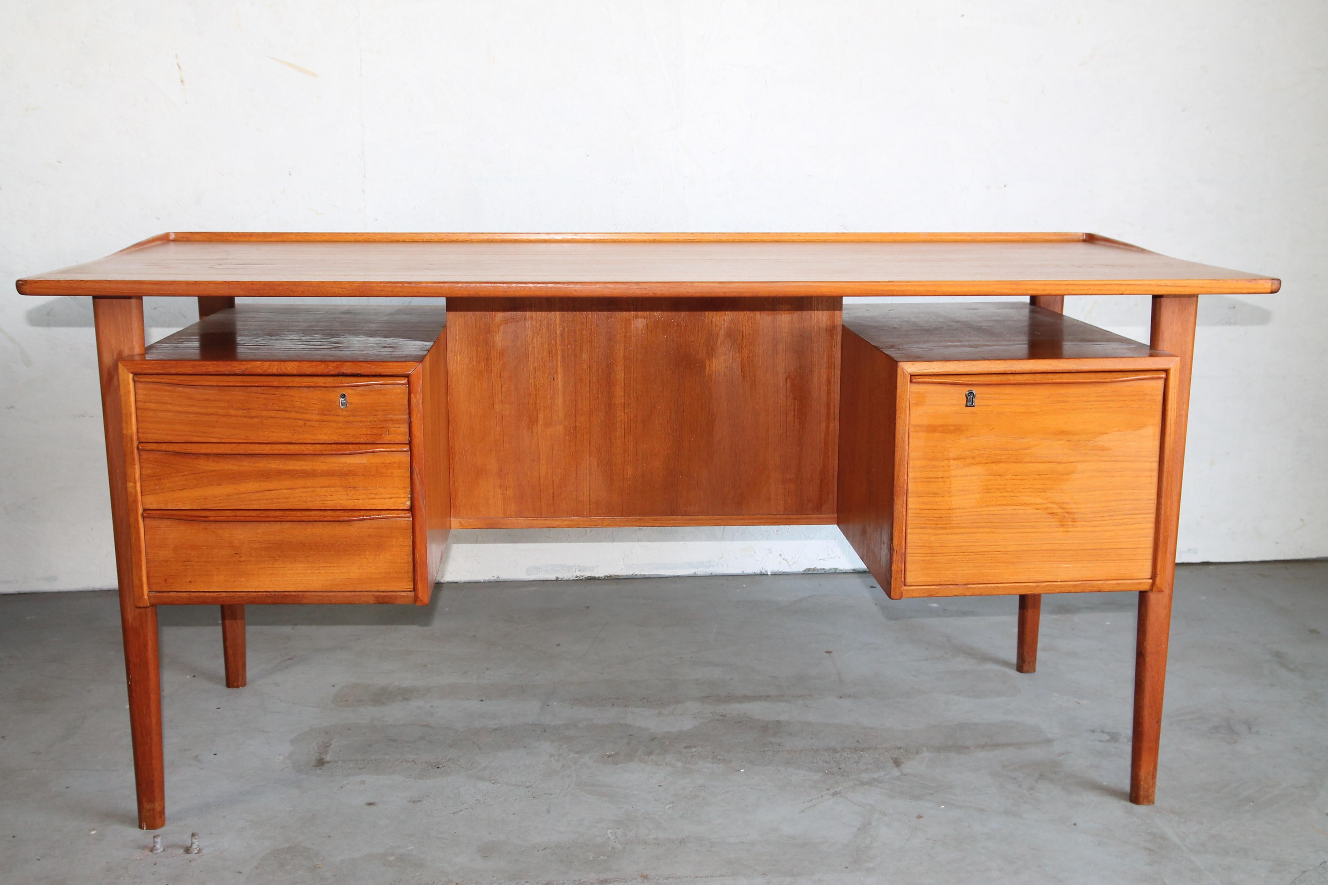 Great teak desk designed by Peter Lovig Nielsen for Lovig Design. Has floating top with file cabinet on the right side and 3 draws on the left. Two nice storage compartments in the front of the desk. See the photos for all the great details.