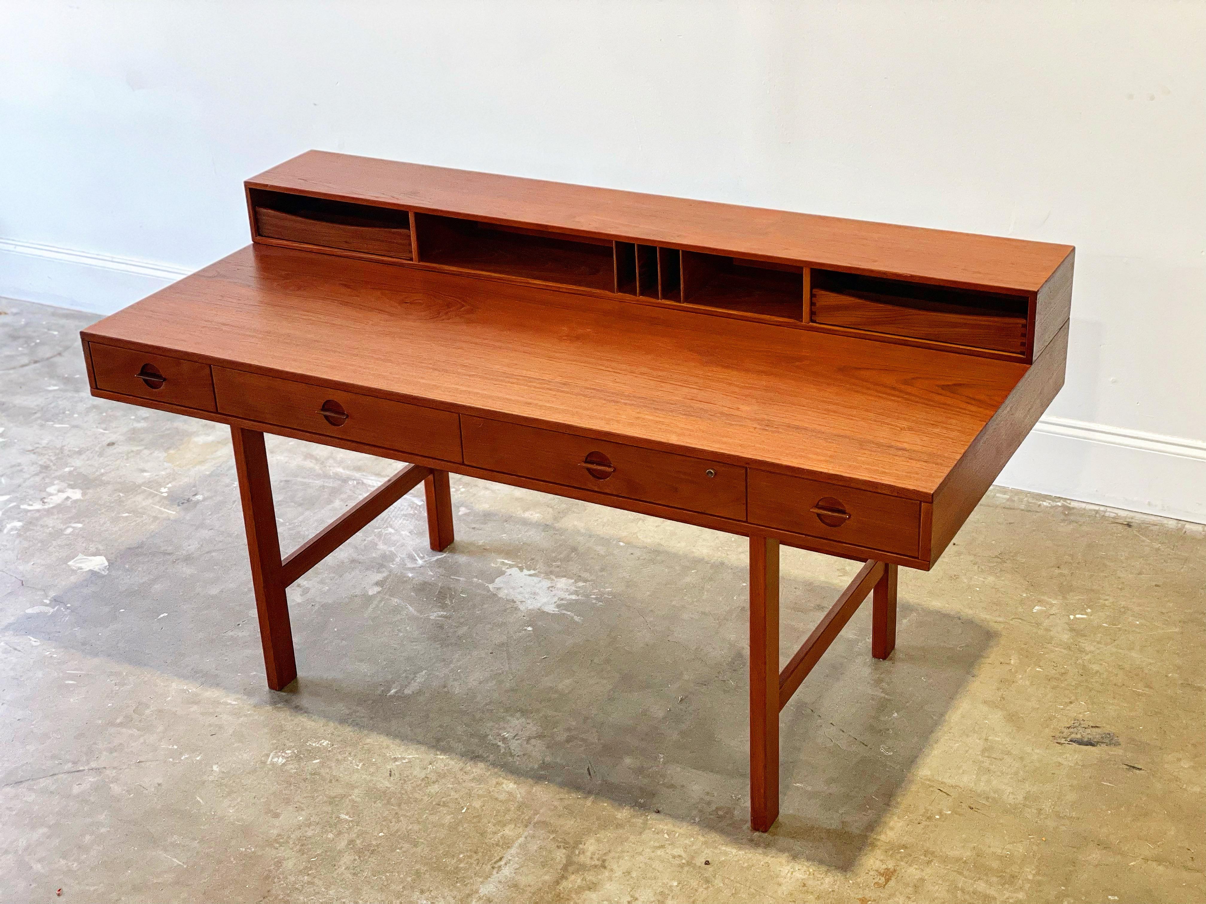 Flip top partner desk by Peter Løvig Nielsen for Lovig Dansk. Gorgeous deep hue old growth teak - built in Denmark and dated 1971. Form, function and versatility. Retains original top tier drawers. Makers burn stamp and build date (1971) on the