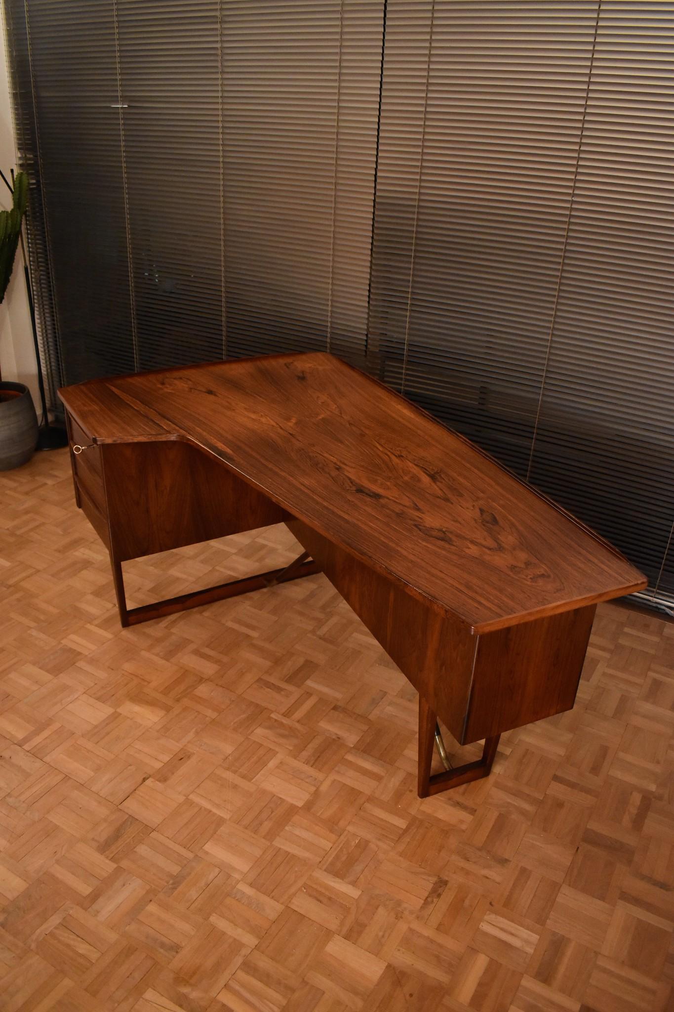 An outstanding asymmetrical desk designed by Peter Lovig Nielsen for Hedensted Mobelfabrik, Denmark.

One of the most handsome desks you can find. This example executed in lush Brazilian rosewood exhibiting wonderful character to the grain.

A