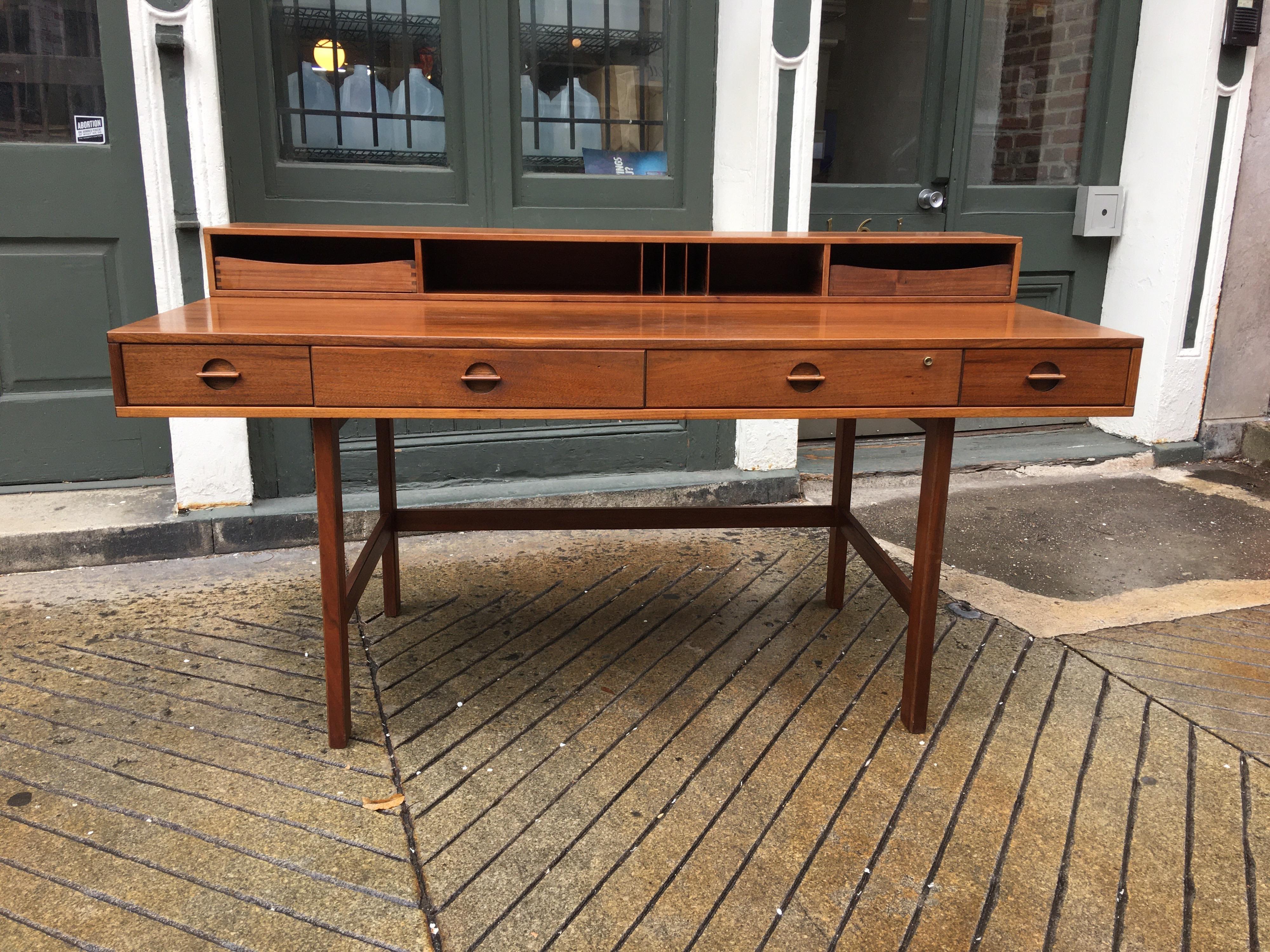 Classic Scandinavian Modern Peter Lovig Nielsen teak desk. Upper Level can flip down to add extra work space or use as a partner's desk. In Small spaces desk can also function as a dining table! This Model is dated 1970. Desk has been cleaned and