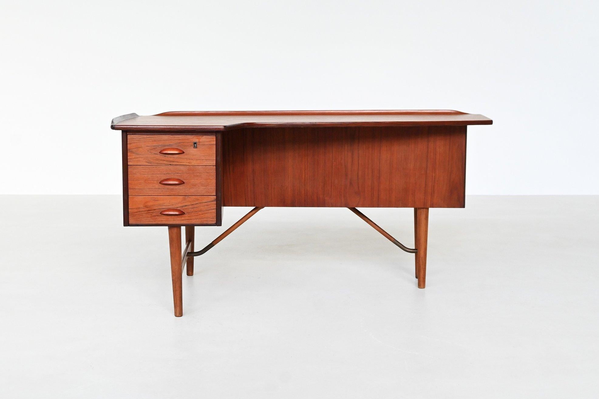 This striking boomerang-shaped writing desk was designed by Peter Løvig Nielsen and produced by Løvig in Denmark circa 1960. A quintessential example of Danish modern design, the desk showcases clean architectural lines, superb craftsmanship, and