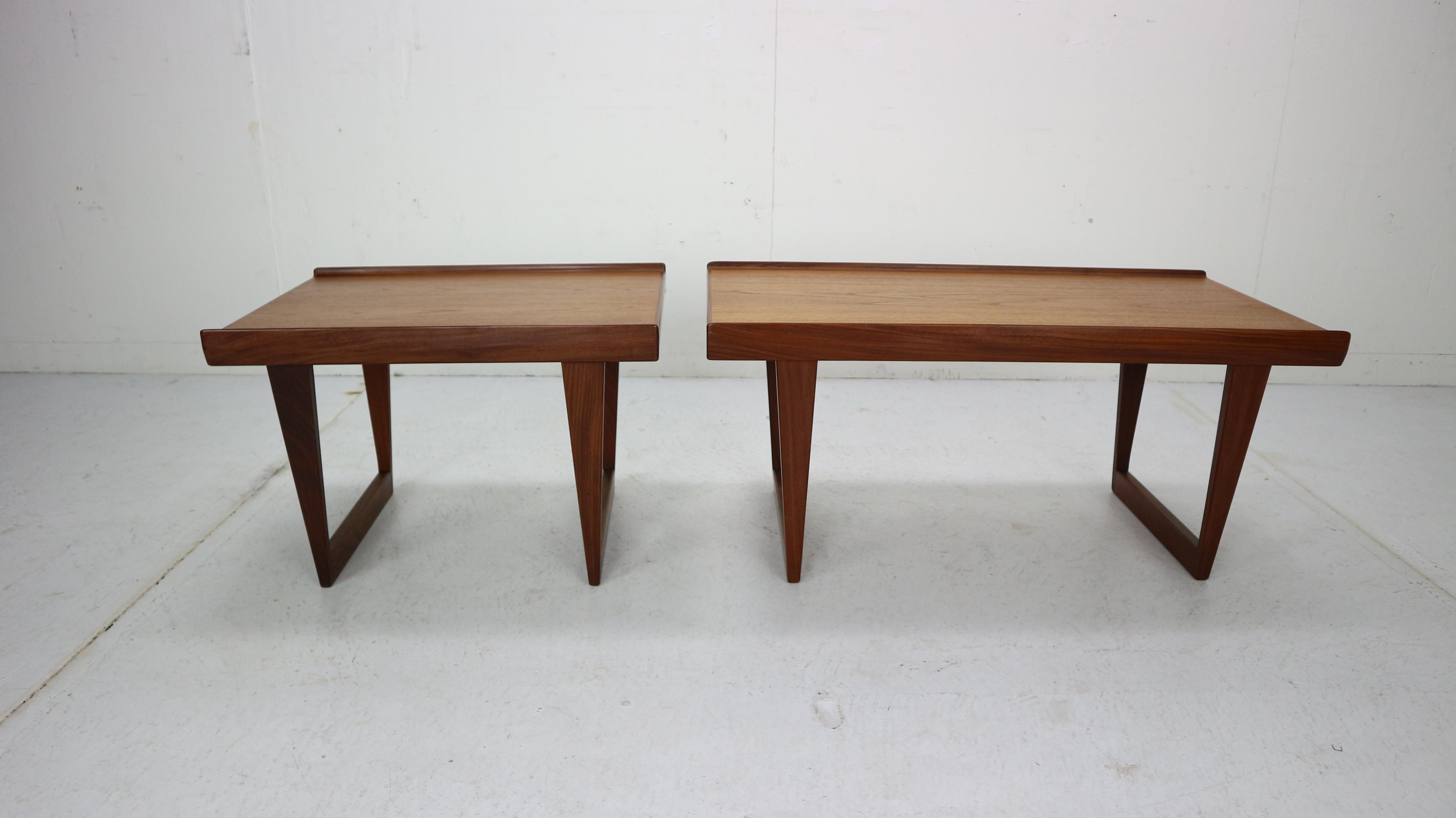 Set of 2 coffee/ side tables designed by Peter Løvig Nielsen and manufactured for Dansk in 1967s, Denmark.
Solid teak legs and channeled sides, table tops has a beautiful wooden patina. Fully signed with burn and mark on the bottom.
Dimensions: