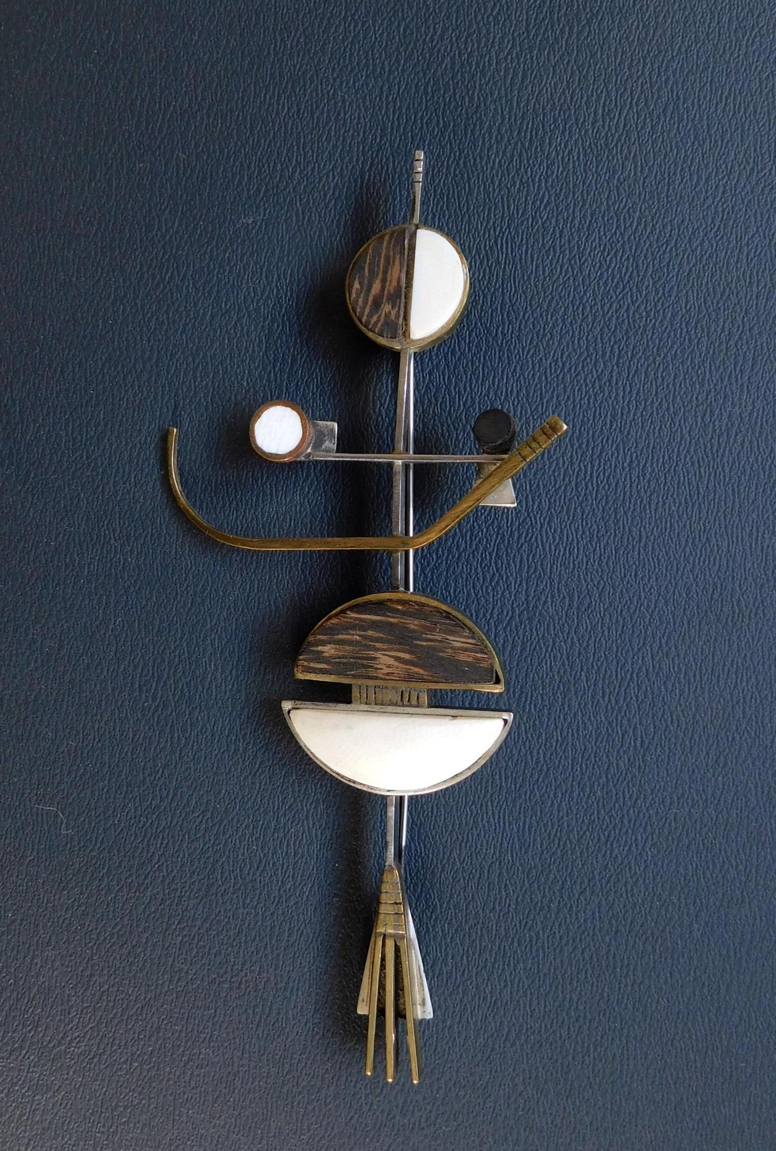 Important abstract elongated geometric form Peter Macchiarini studio brooch. 
Copper and sterling set with ebony, bone and mahogany in spherical and hemispherical shapes. 
The brooch is quite large and measures 6