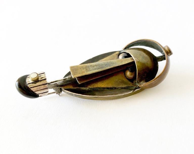 Rare sterling silver, brass, wood and oxidized silver brooch created by Peter Macchiarini of San Francisco, California.  Brooch measures 3.5