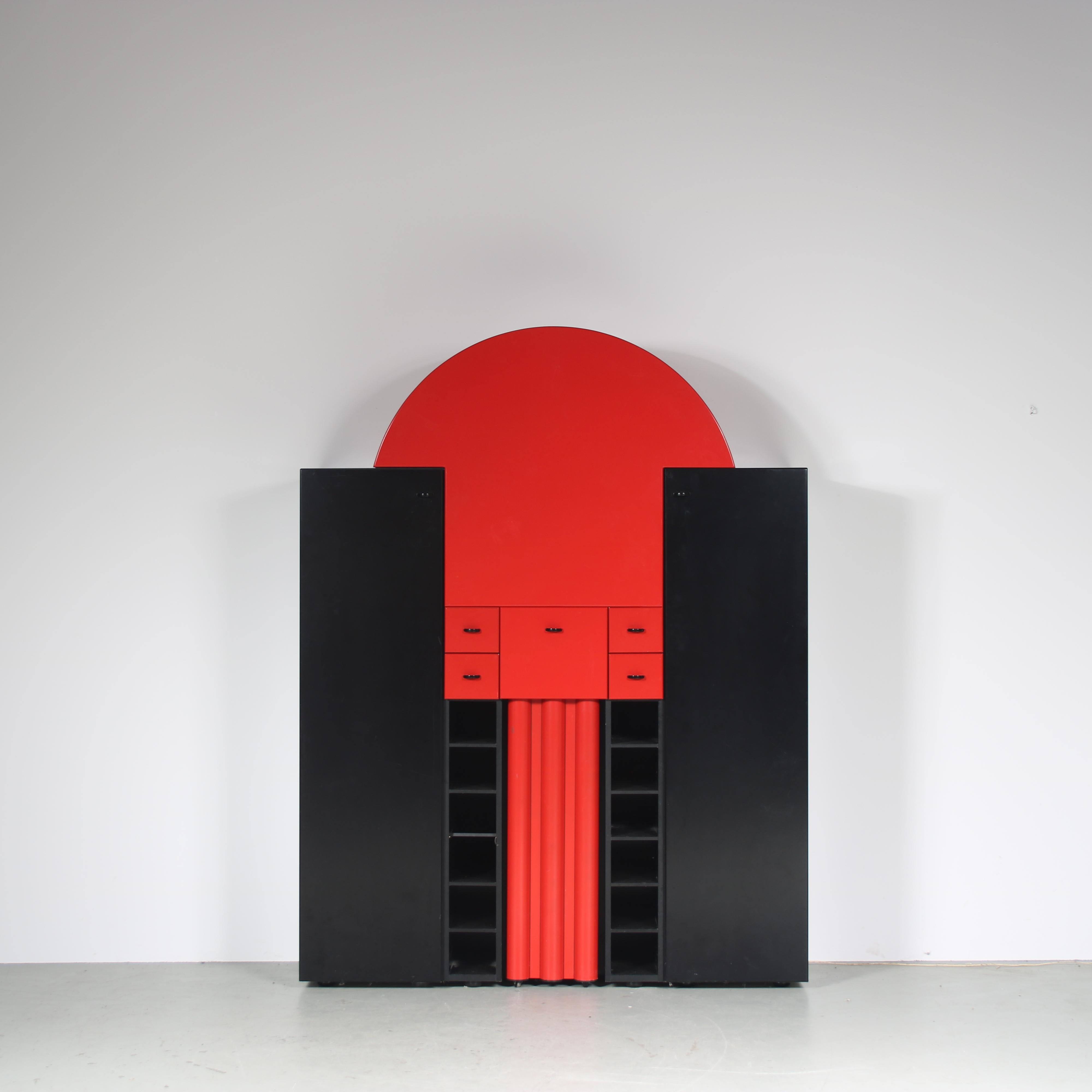 An eye-catching bar cabinet, model “Duo”, designed by Peter Maly and manufactured by Interlübke in Germany around 1980.

This piece has a unique, post modern style that combines round and square shapes in contrasting black and red laminated wood. It