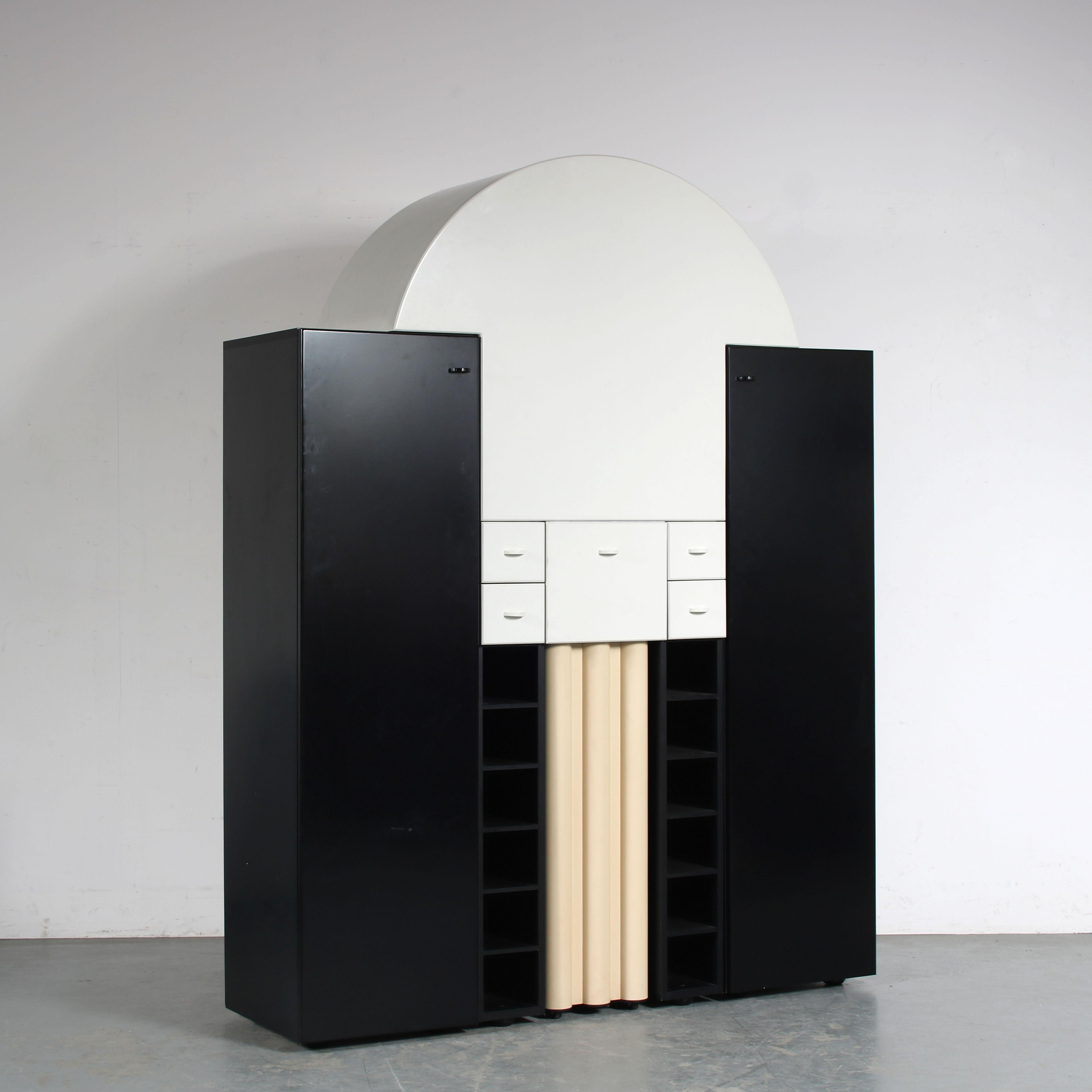 An eye-catching bar cabinet, model “Duo”, designed by Peter Maly and manufactured by Interlübke in Germany around 1980.

This piece has a unique, post modern style that combines round and square shapes in contrasting black and white laminated wood.