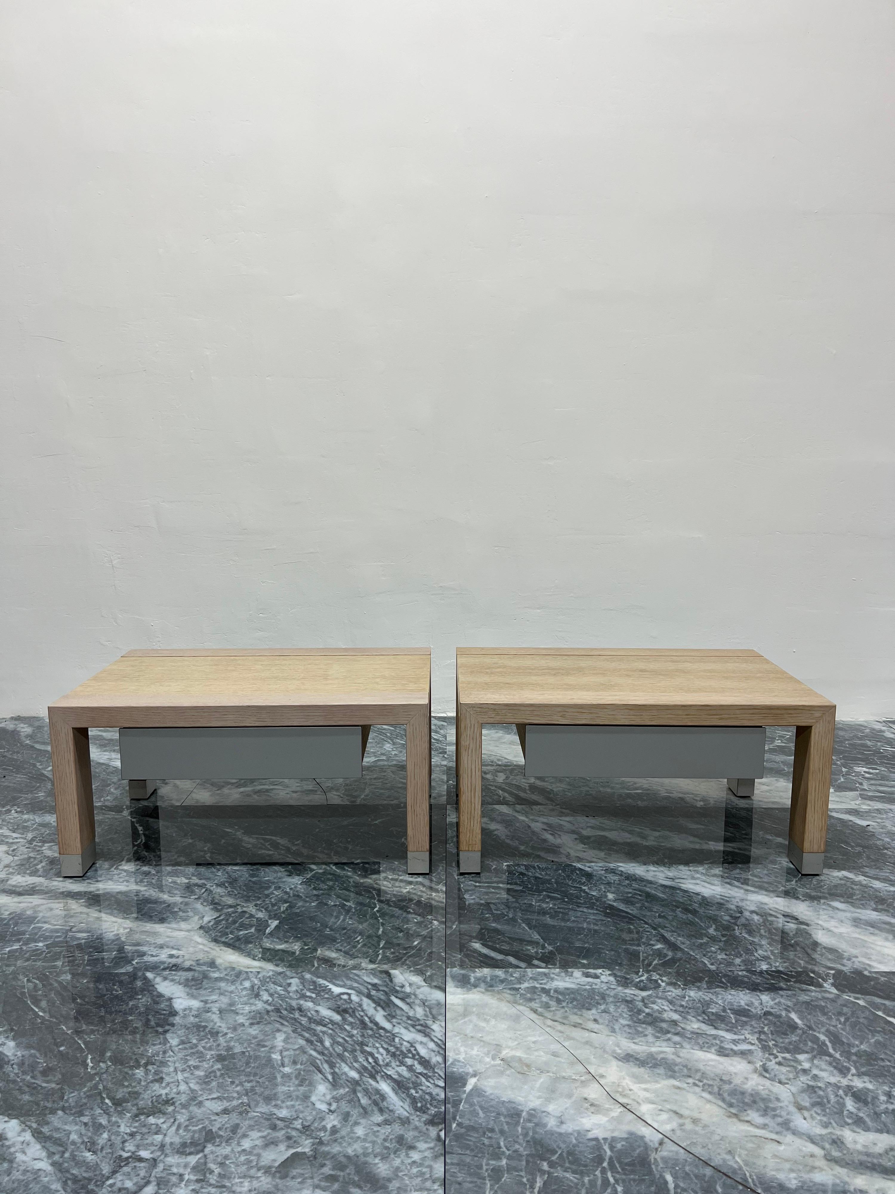 Pair of contemporary Lumeo low nightstands or bedside tables with drawers designed by Peter Maly for Ligne Roset. Constructed with a blonde oak hardwood frame and aluminum detailing.