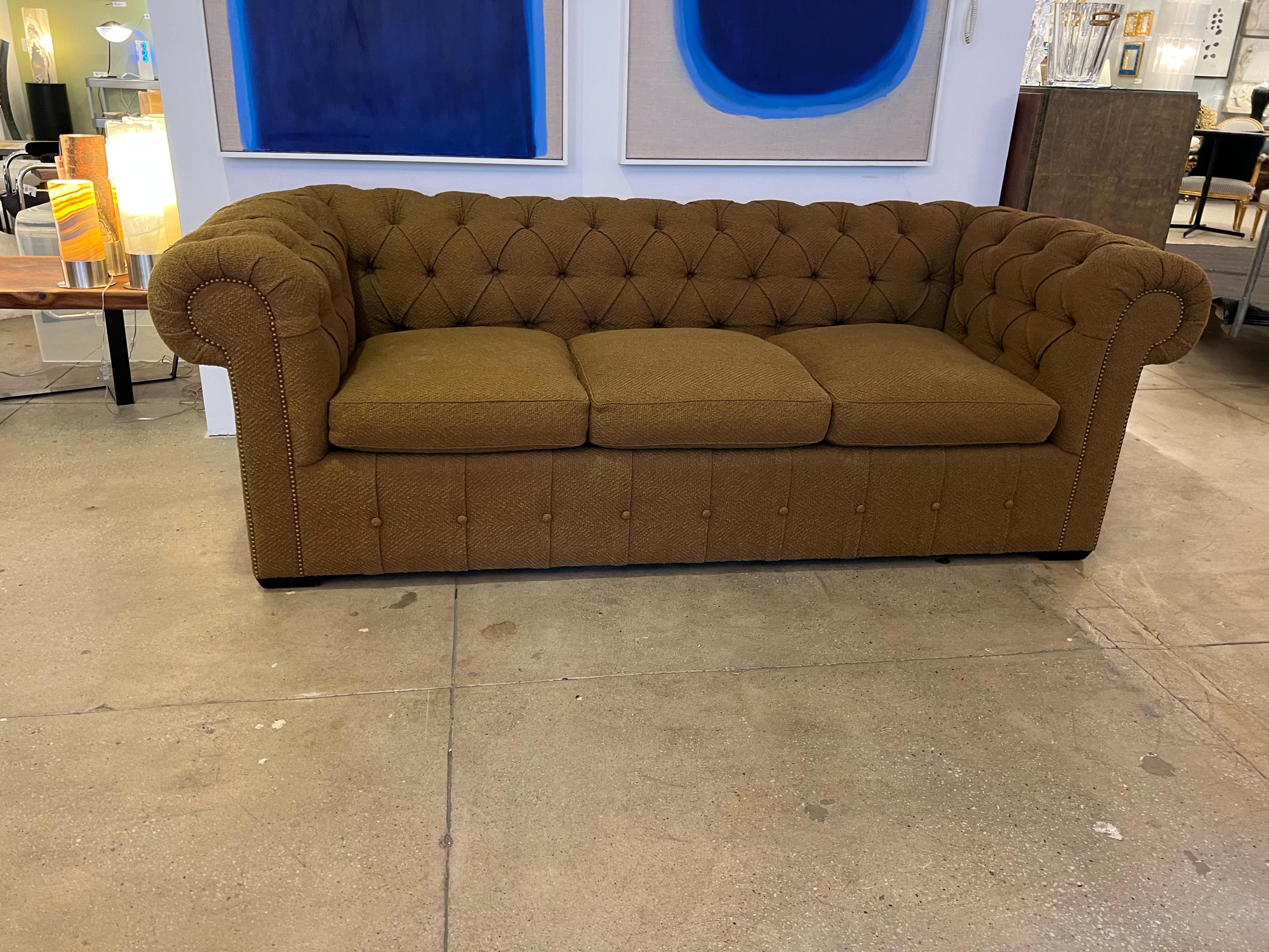 A very comfortable luxurious custom modern take of a classic chesterfield sofa by famed designer, Peter Marino. Excellent shape. 
The color is a medium to light brown with hints of green, Nightingale Brown.
