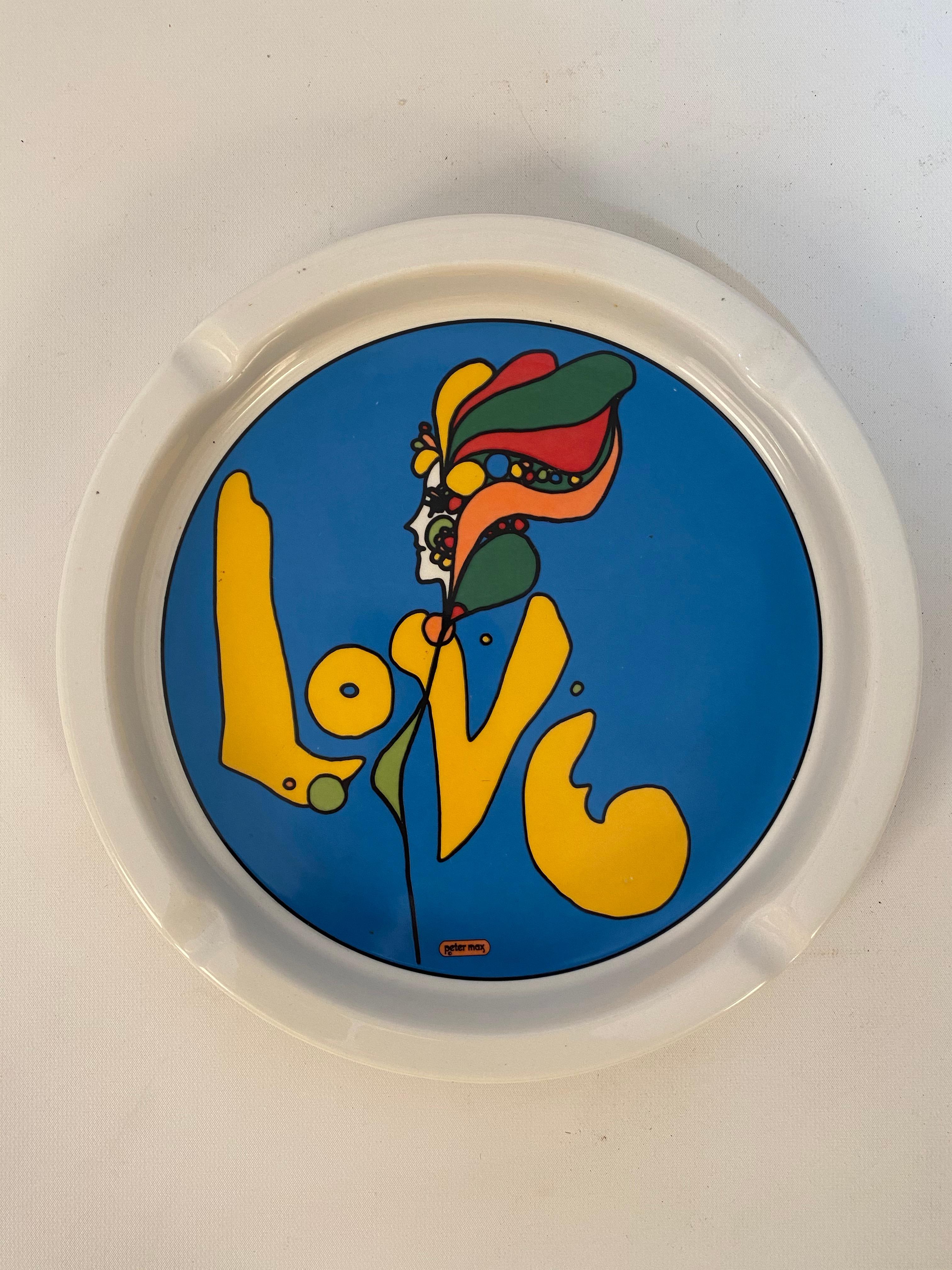 Peter Max's psychedelic 1960s Love ashtray by Iroquois China, Syracuse, NY. Wonderful vibrant transfer decorated image. Very little wear or use and in amazing condition; no chips, cracks, hairlines or cigarette butt burns. Signed on