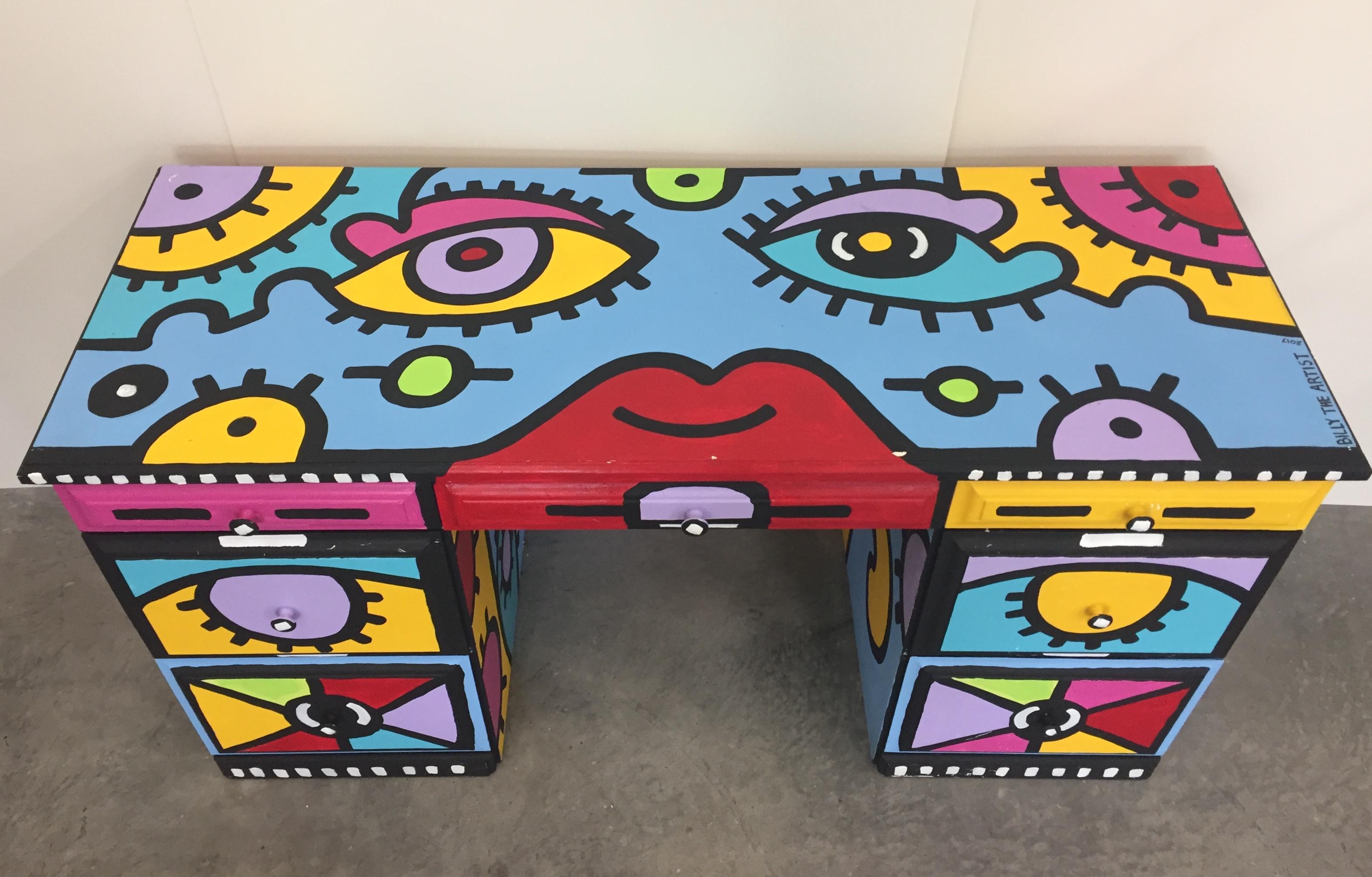 One of a kind bold modern desk painted in the style of Peter Max by a Billy the Artist in NYC , having cartoonish designs in turquoise, magenta, yellow and lavender, all outlined in black. 3 drawers across the top and 2 larger drawers on each side.