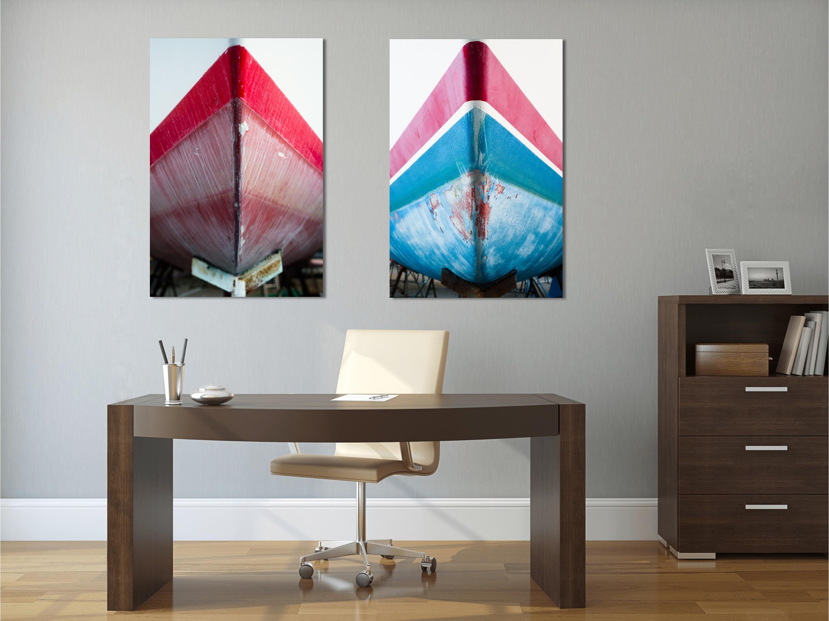 This abstract nautical contemporary photograph by Peter Mendelson pictures a close-up view of a red, white, and blue boat prow. The image is shot from an angle that creates a triangular shape with a the red rim of the boat appearing to point upward.