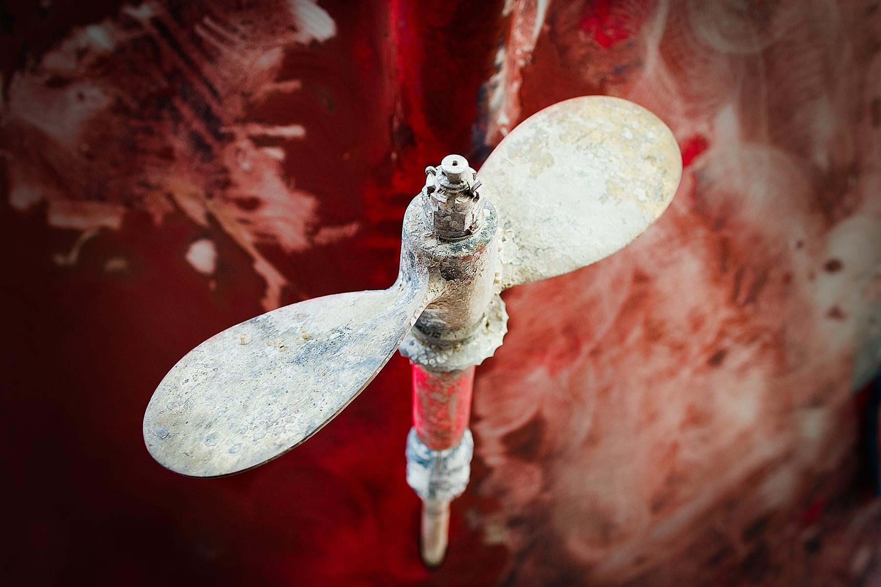 Peter Mendelson Color Photograph - "Corroded Propeller II (Red), " Contemporary Nautical Photograph, 24" x 36"