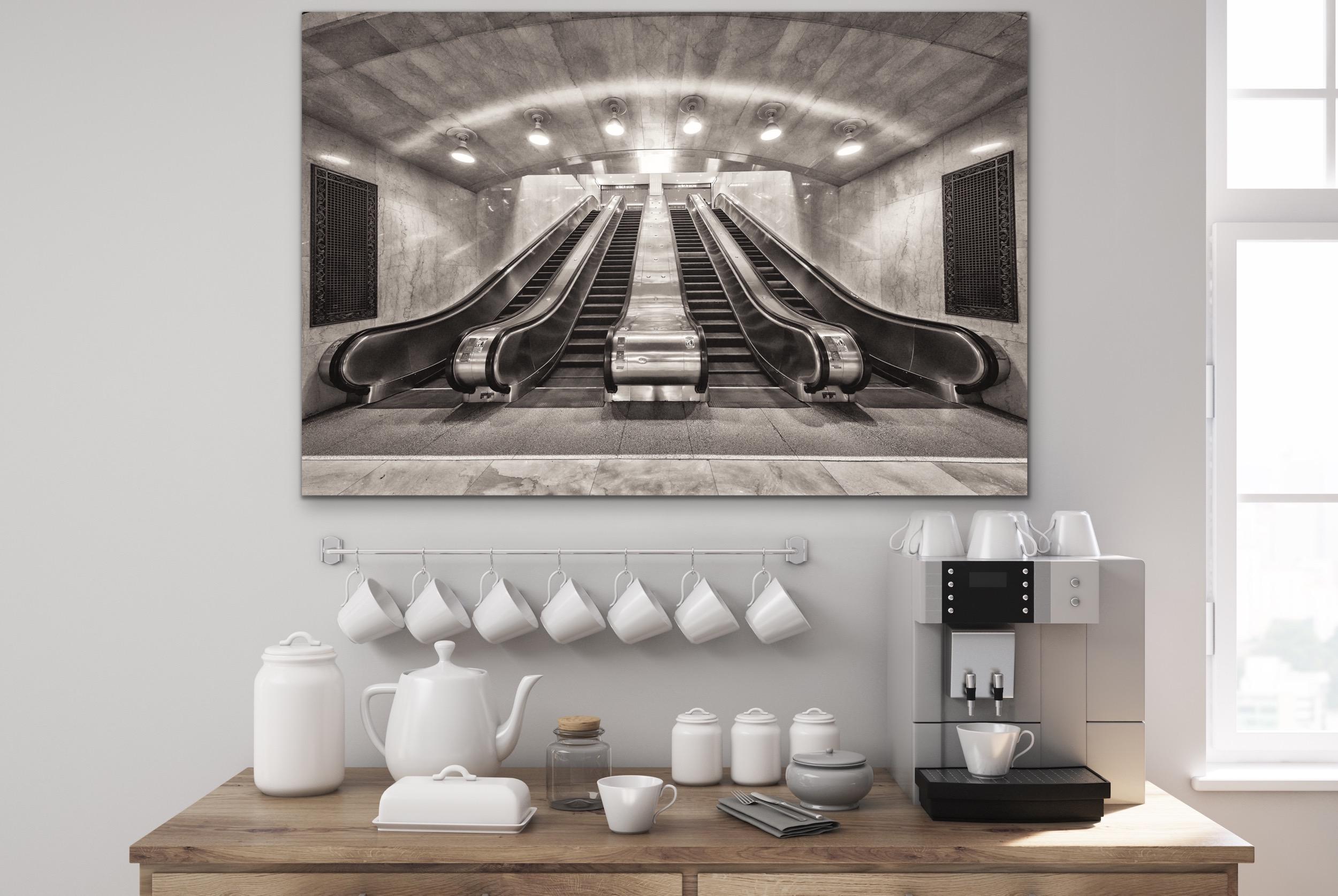 This black and white, contemporary architectural photograph by Peter Mendelson features the Oyster Bar Restaurant entry way in Grand Central Station in Manhattan. Staircases lead down to a lower level on either side of the doorways, and patterned,