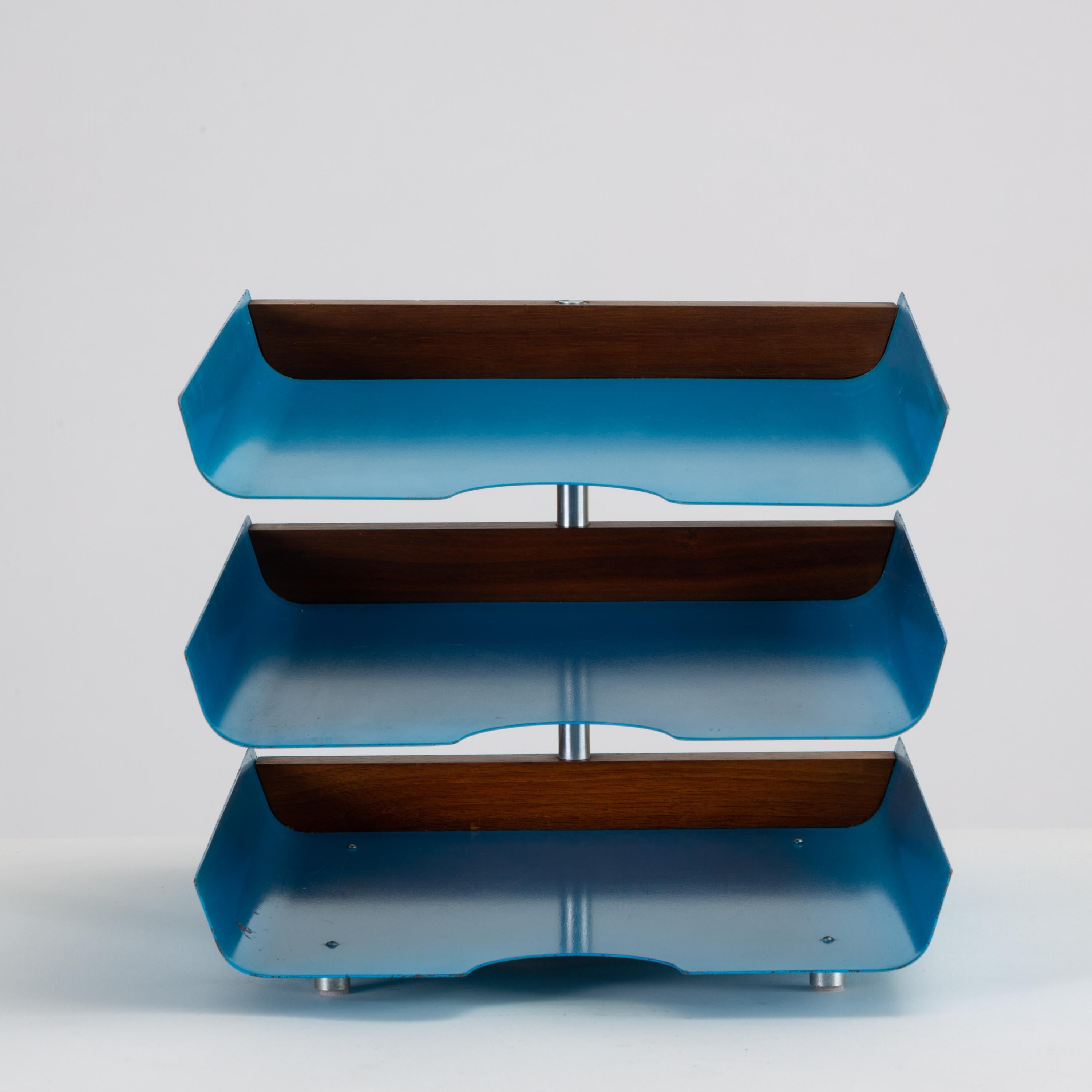 Peter Pepper Products three-tiered paper tray in original blue enamel.

A 1950s in/out tray for office or study has three tiers in enameled steel that rotate around a central post of brushed steel. Each drawer is a bright, cerulean blue, and the