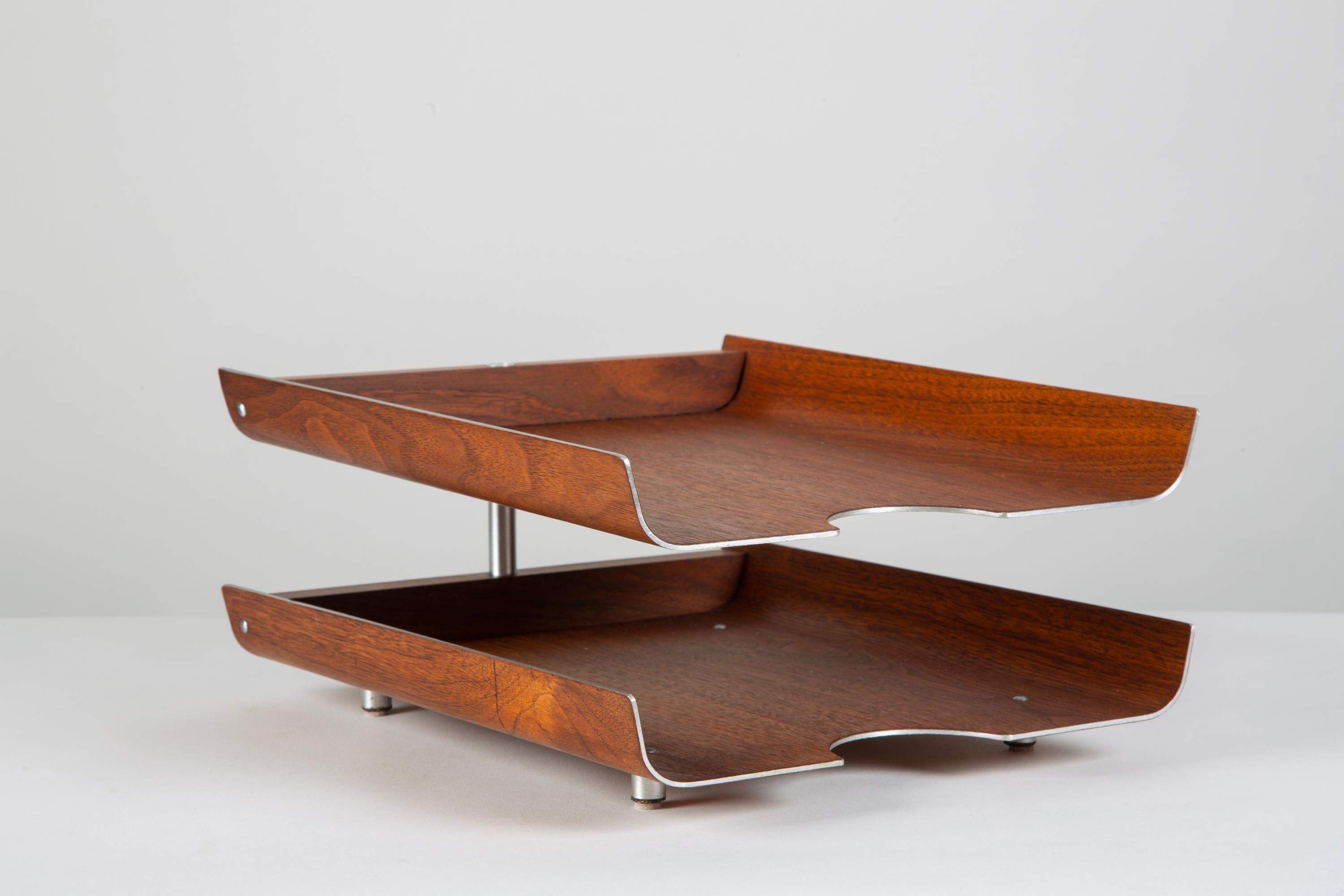 The 1950s in/out tray for office or study has two tiers, in original bent teak plywood with an aluminum core. The trays rotate around a central post of brushed steel.

Tray bottoms retain the original manufacturer’s label.

Dimensions: 10
