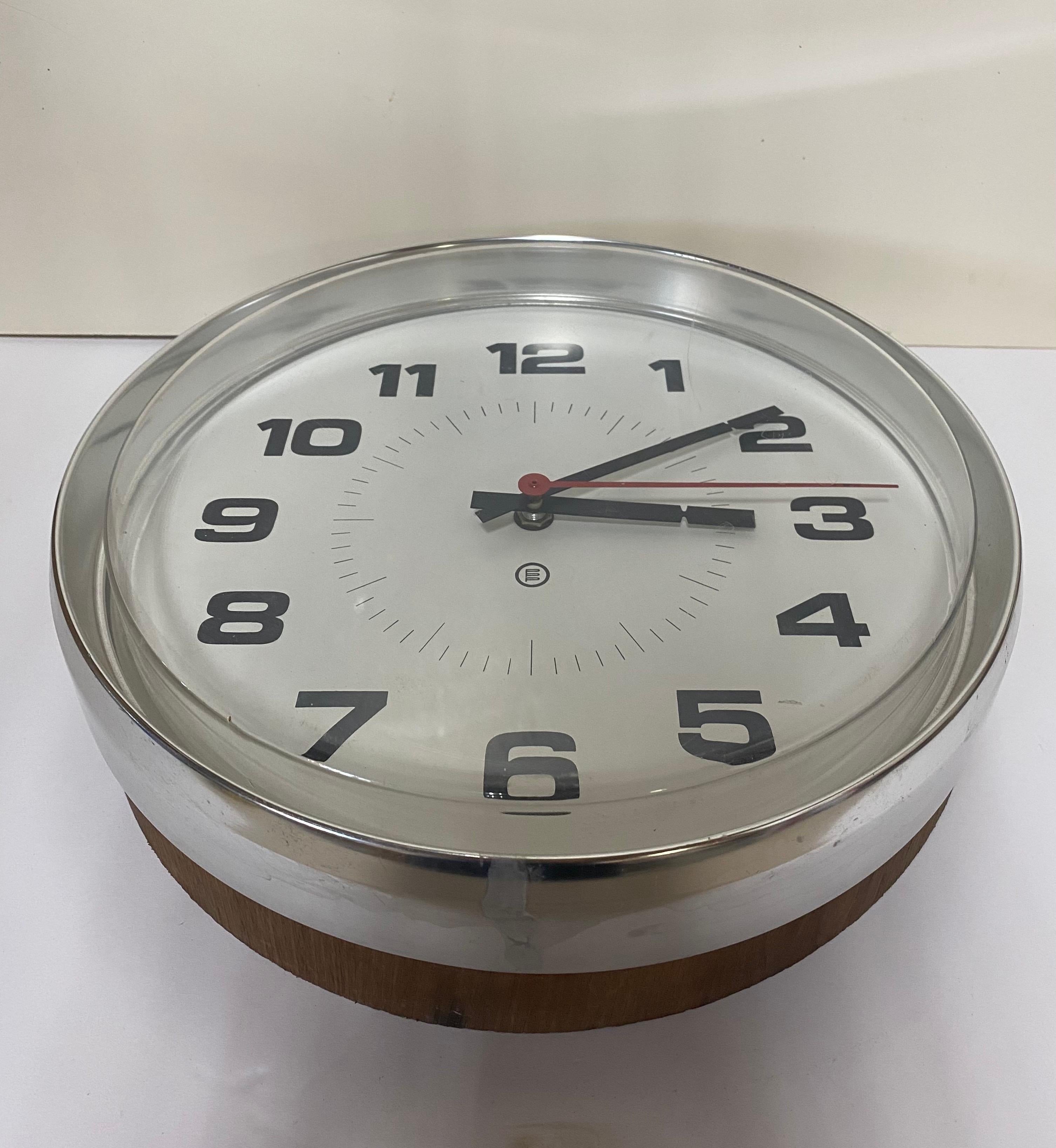Round wall clock made by Peter Pepper Products. USA, circa 1960.

Chrome case complemented by black numerals on white face. Signed on face and ith sticker on back.

 
