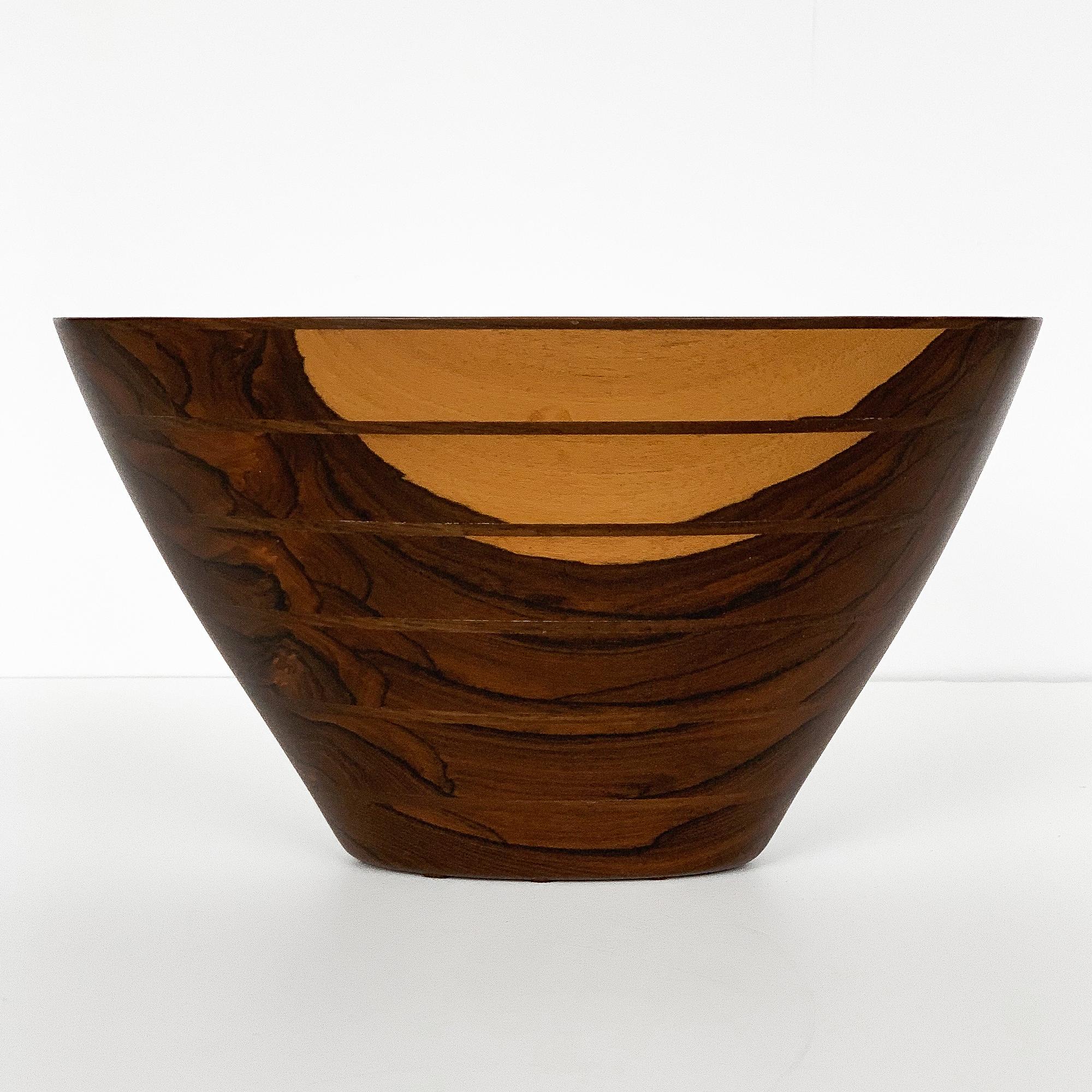 Handcrafted wooden bowl by Peter M Petrochko. Carved laminated padauk and ziricote woods. Signed and dated July 1987. Oval shaped bowl with dramatic grain patterning. Base measures: 4.5