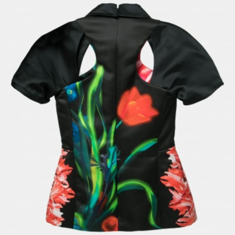 A little bit of color is good to elevate any outfit. From Peter Pilotto comes this top which is fashioned in black satin fabric, highlighted with floral prints, and elevated with cut-outs. It features collars, zip fastening, and short sleeves. This