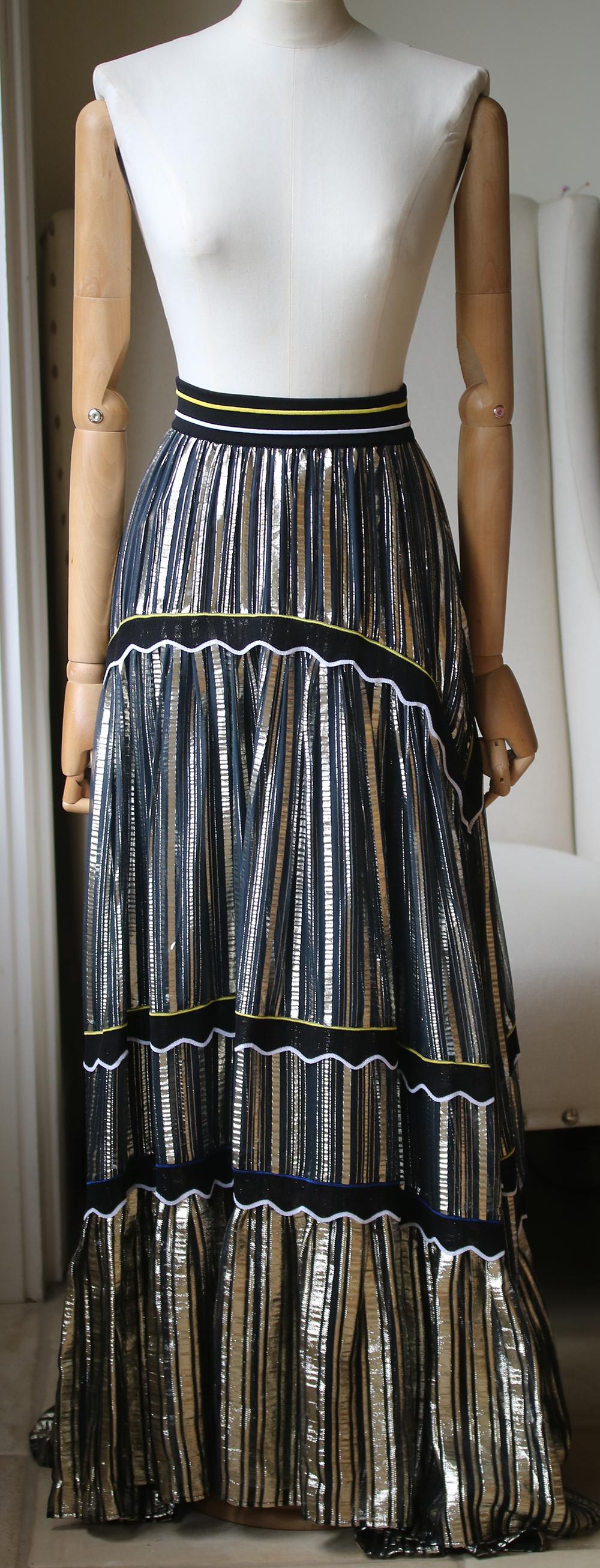 Cut from silk-blend chiffon woven with light-catching gold stripes, this maxi skirt is tiered with scalloped trims and has a ribbed elasticated waistband for a sporty feel. Black and gold silk-blend chiffon, black stretch-knit. Pulls on. 62% silk,