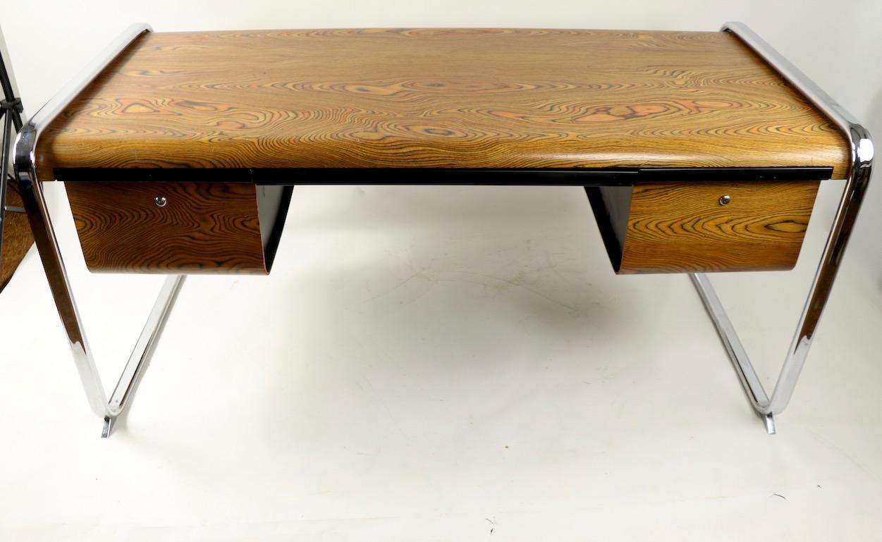Chic modernist desk designed by Peter Protzmann for Herman Miller having a stunning zebra wood body with three drawers, supported by continuous loop chrome legs. This desk was produced only two years (1970-1971 ) making it rare and hard to find.