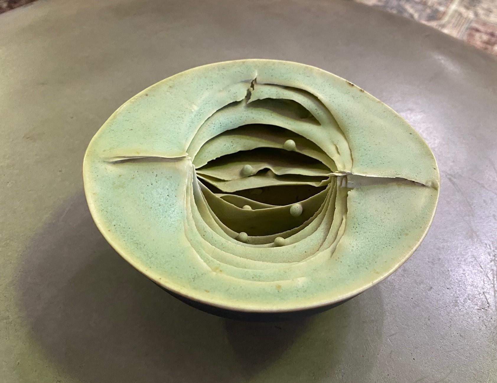A wonderful free-form organic bowl vessel by acclaimed British potter Peter Simpson. 

Simpson's works, such as this early piece, are inspired by organic forms in nature such as pomegranates, mushrooms, poppy seedpods. etc. This rounded bowl form,