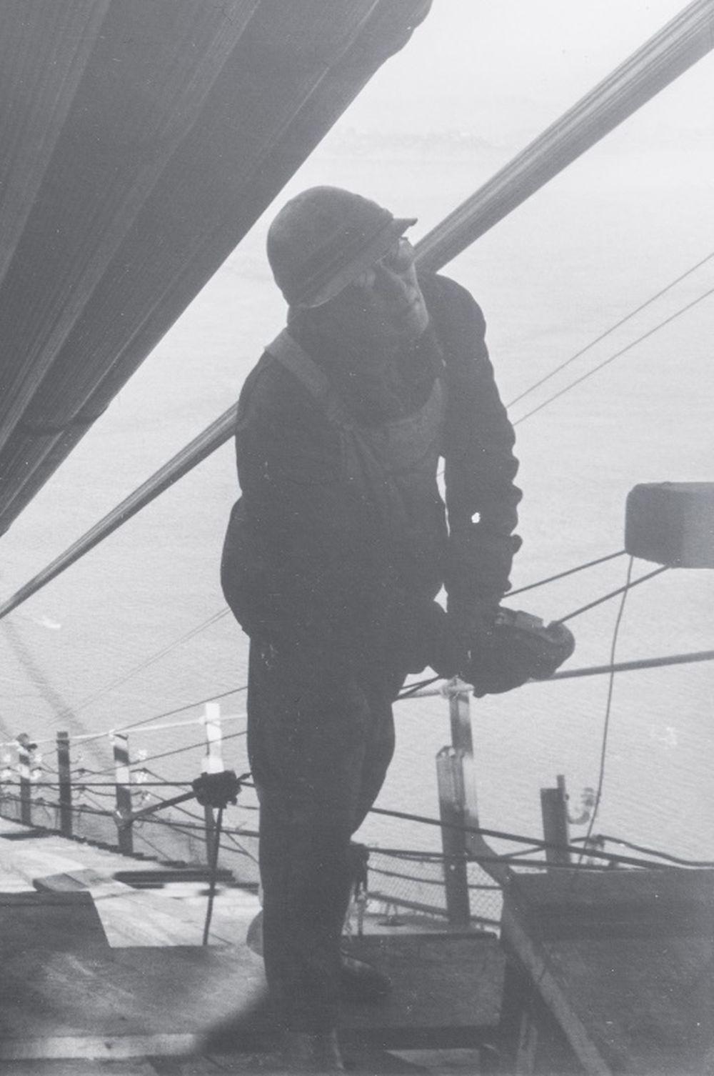 Peter Stackpole (American, 1913-1997), Golden Gate Bridge Workers, Gelatin Silver Print Photograph, 1936, depicting the construction of the Golden Gate Bridge with two workers in the foreground, signed in pencil and dated lower right, frosted white